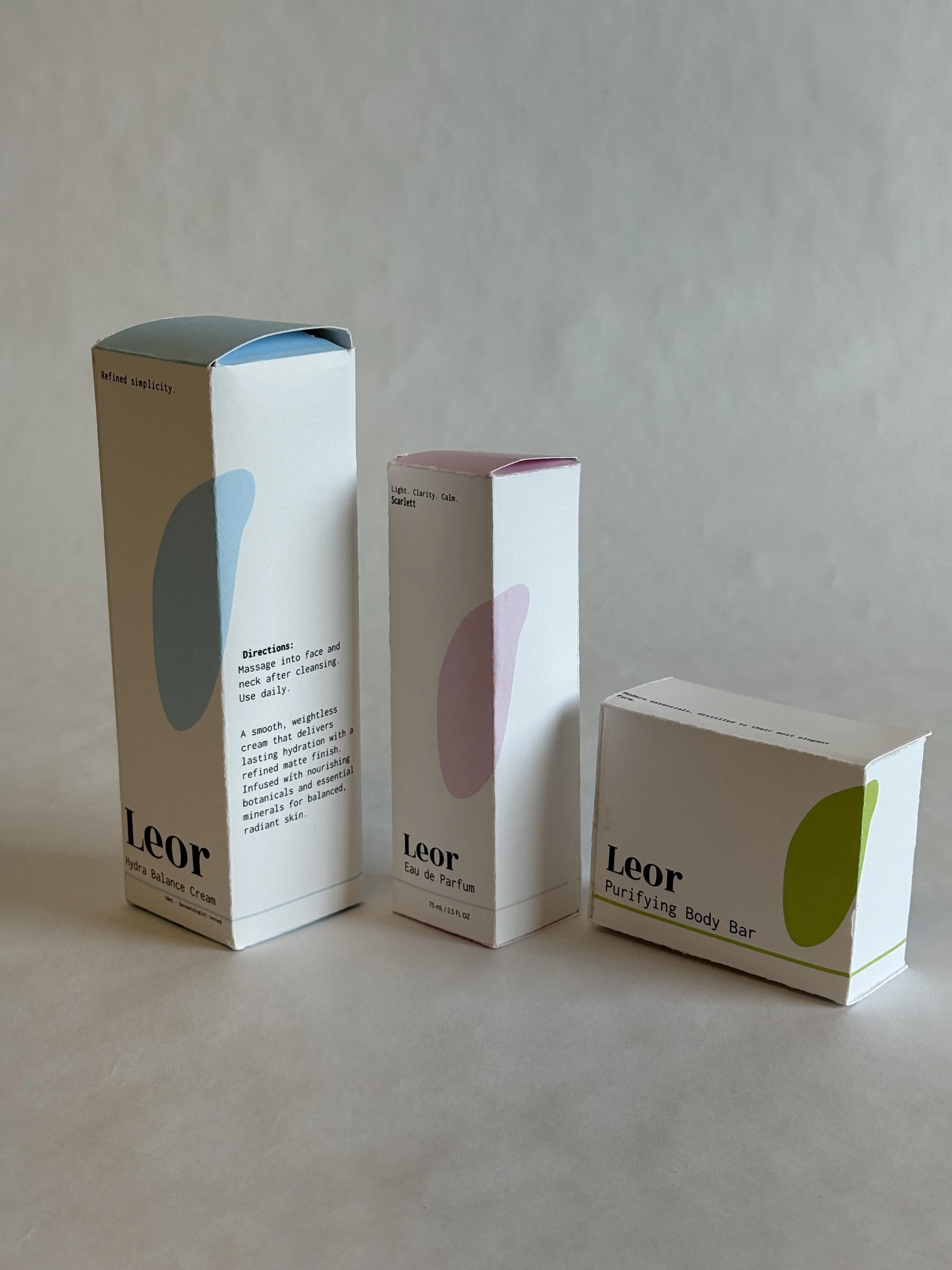 Three skincare product boxes from the brand Leor arranged in a row on a neutral background.
