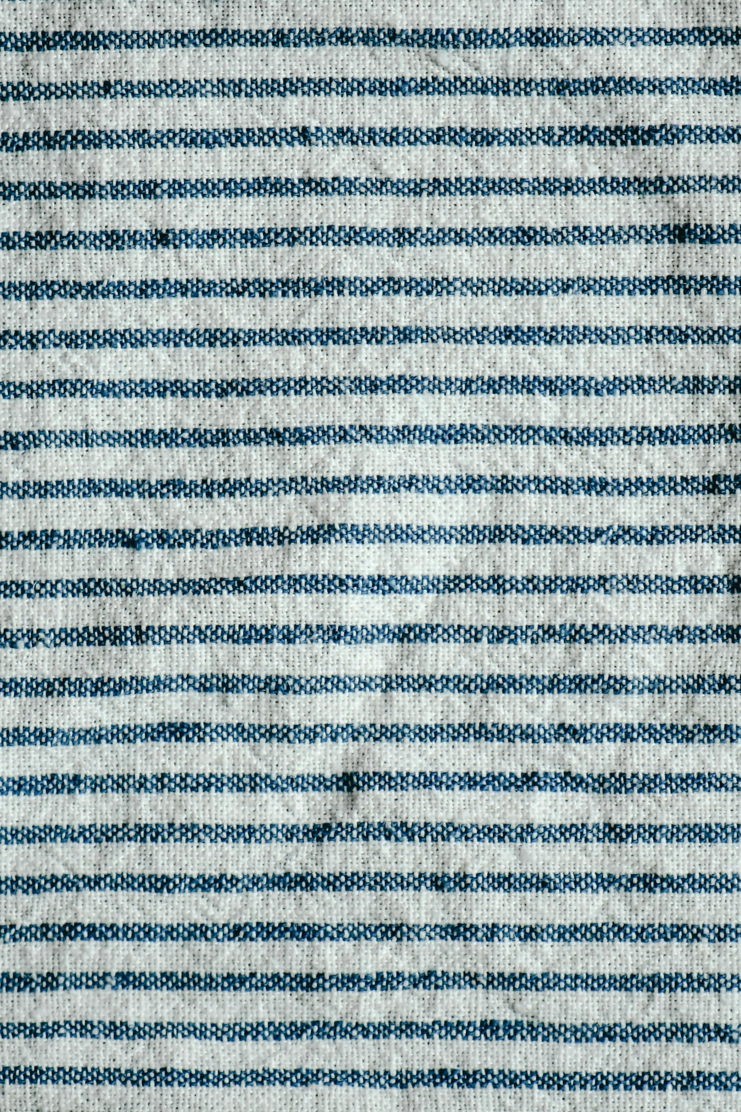 Close-up of a fabric with horizontal white and blue striped pattern.
