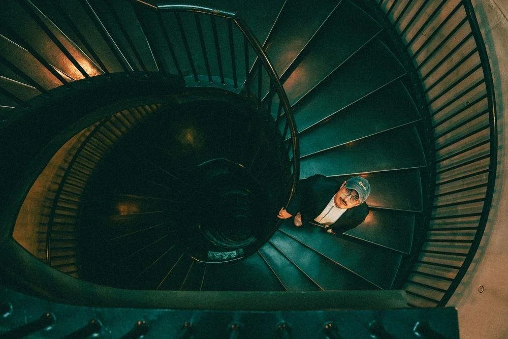 Man walking along a curved staircase, representing the process of changing repeated relationship patterns
