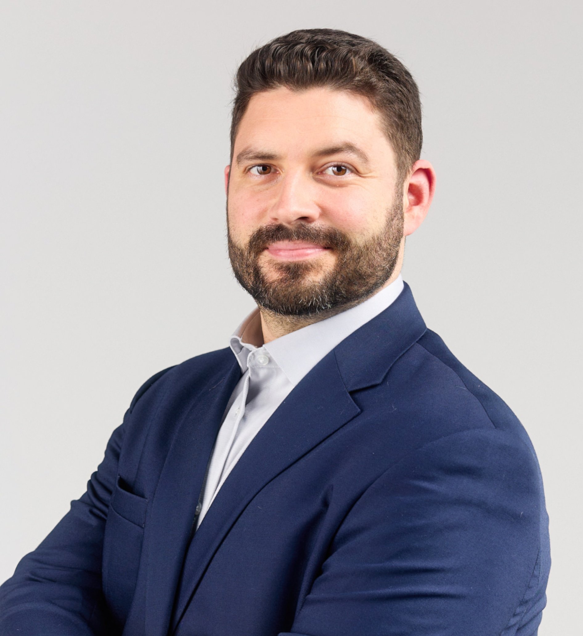 This is a headshot of Renaud Laliberte with a blue suit and white shirt.