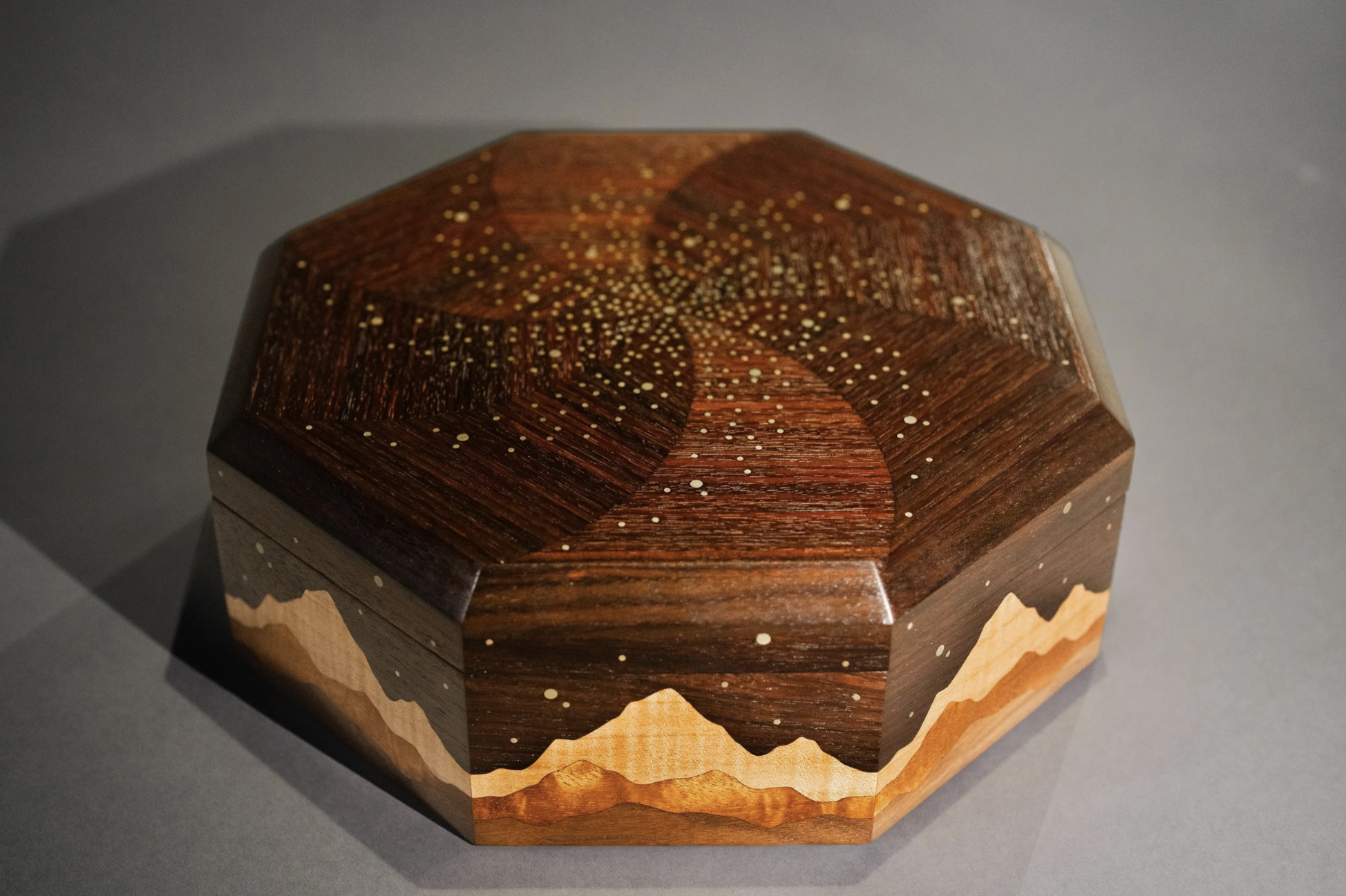 Octagonal Galaxy engagement box with mountain inlay and brass star details.