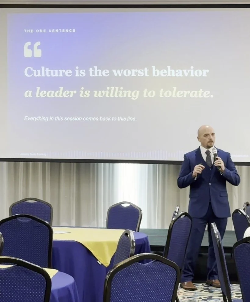 Jeremy Serio on stage presenting the line: Culture is the worst behavior a leader is willing to tolerate