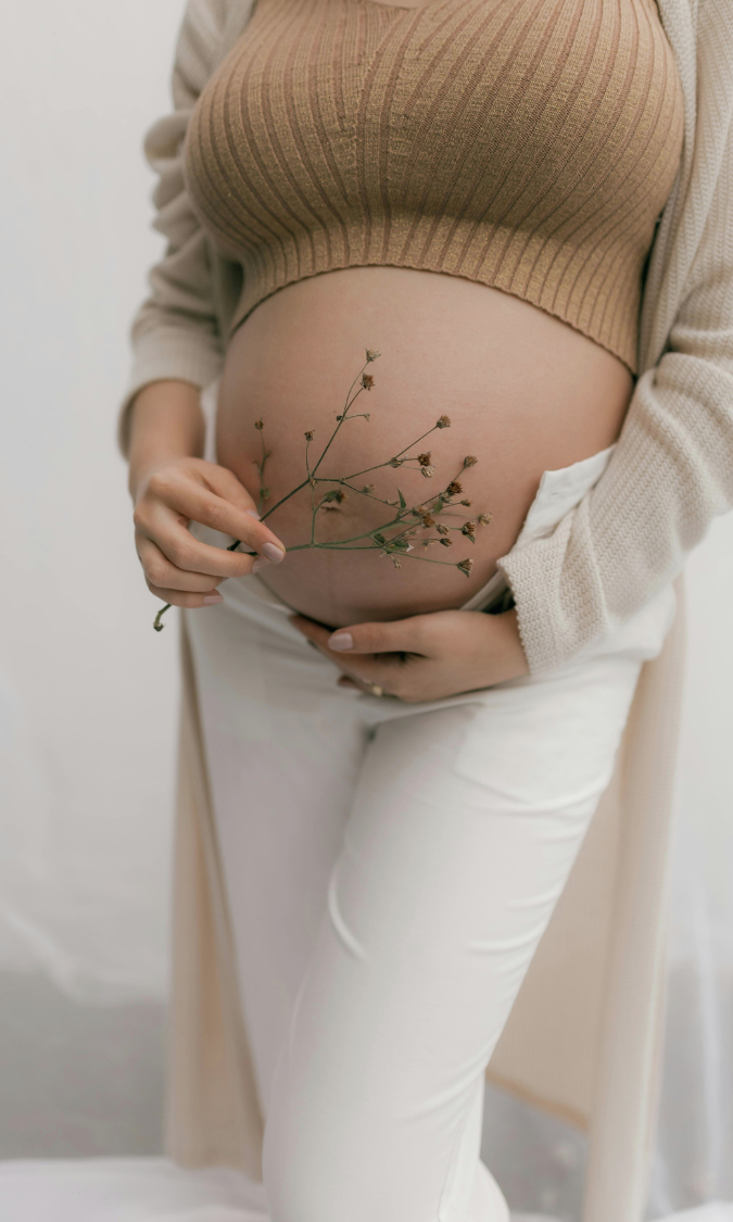 pregnant mother holding belly in natural childbirth class setting Alpharetta GA