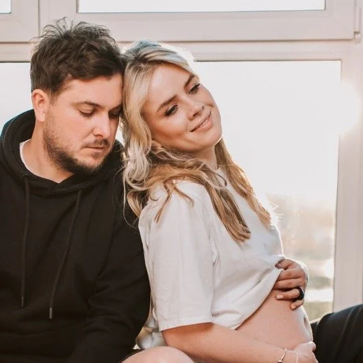 pregnant couple sitting together preparing for childbirth class Alpharetta GA