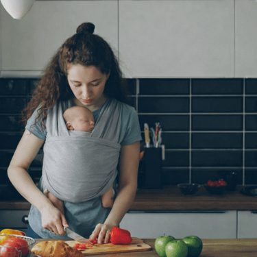 mother preparing food with newborn baby postpartum eating and living well Alpharetta GA