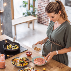 pregnant woman cooking healthy food eating and living well pregnancy nutrition Alpharetta GA
