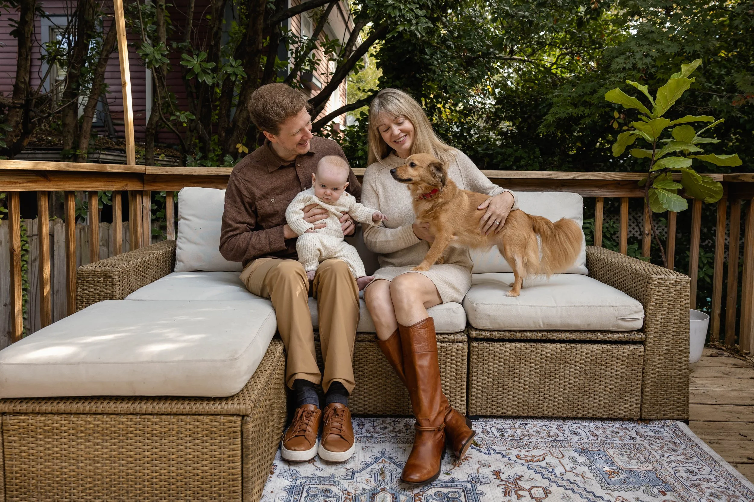 Family and new baby with puppy outside