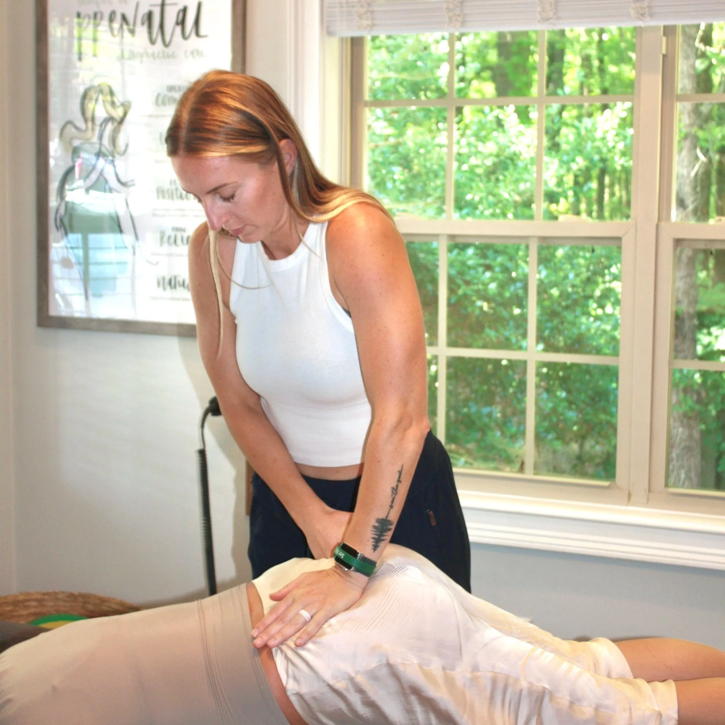 Dr. Mallory at Crew adjusting a pregnant client