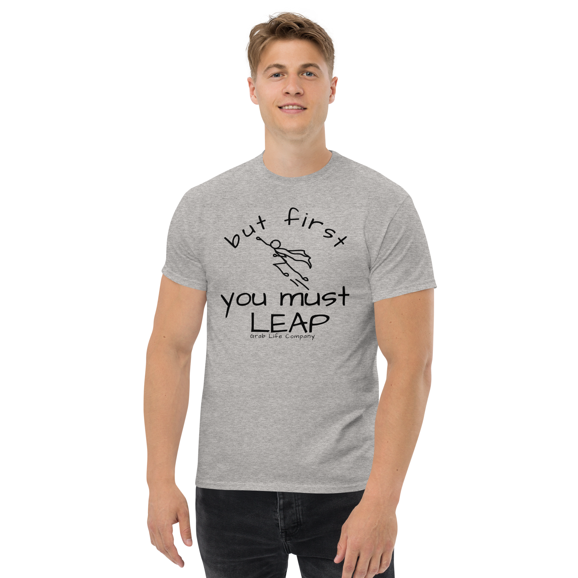 Grab Life Company t-shirt with But First You Must LEAP printed in black on front of sport grey shirt. Image shows a man wearing the shirt.