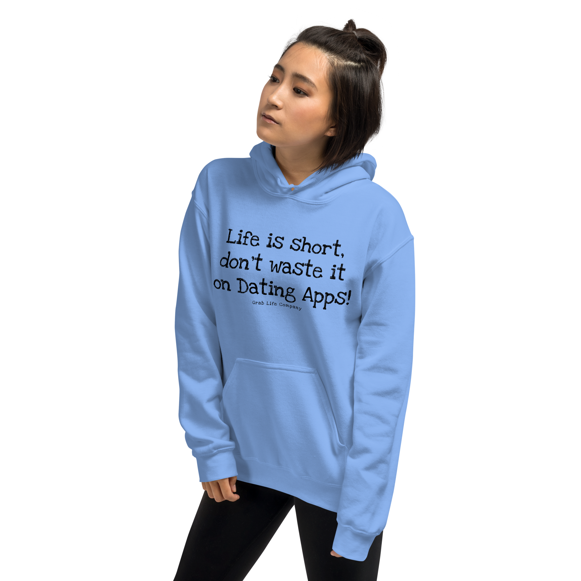 Grab Life Company unisex sweatshirt with Life is Short Don't Waste it on Dating Apps printed in black on Carolina blue hoodie. Image shows woman wearing the sweatshirt.