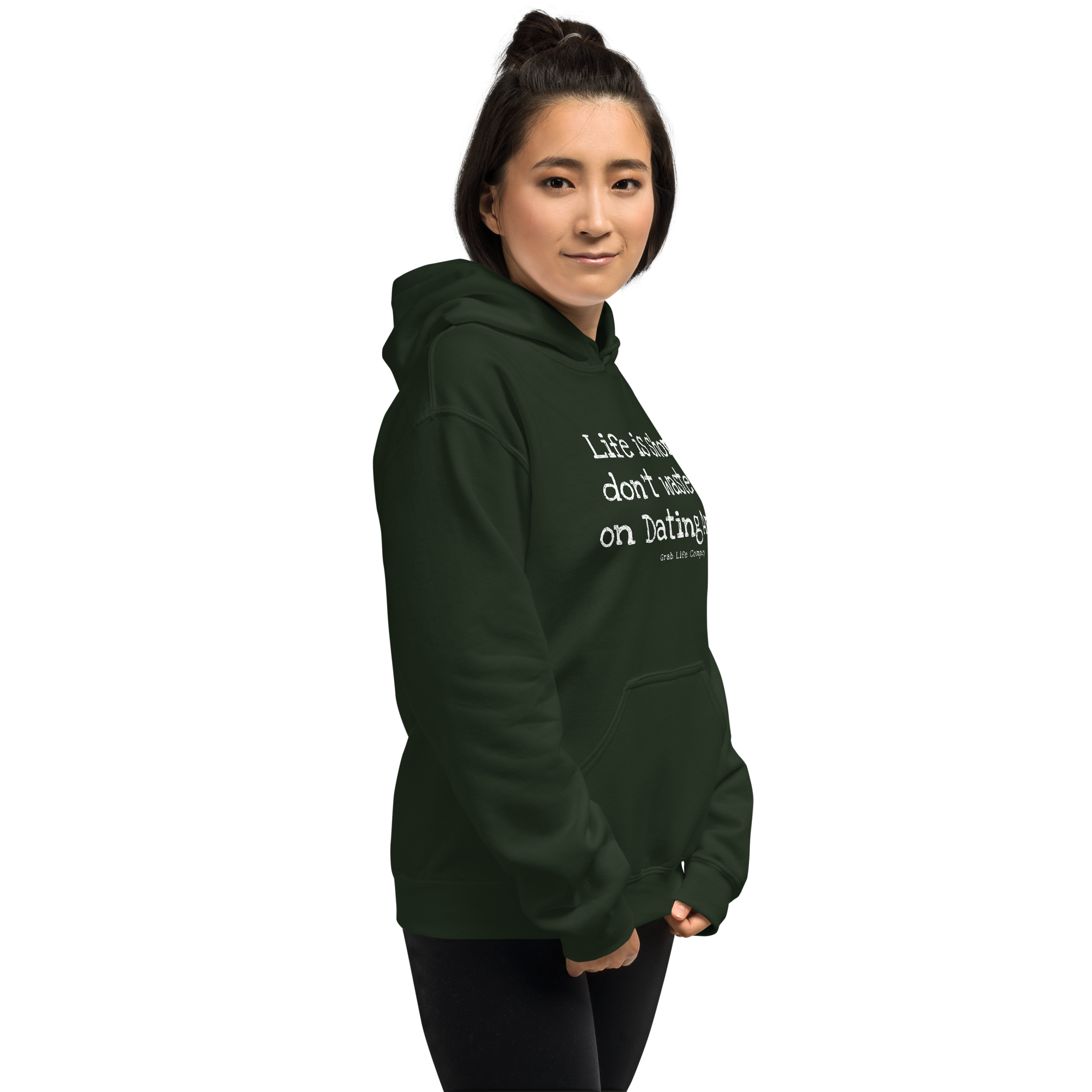 Grab Life Company unisex sweatshirt with Life is Short Don't Waste it on Dating Apps printed in white on forest green hoodie. Image shows woman wearing the sweatshirt.