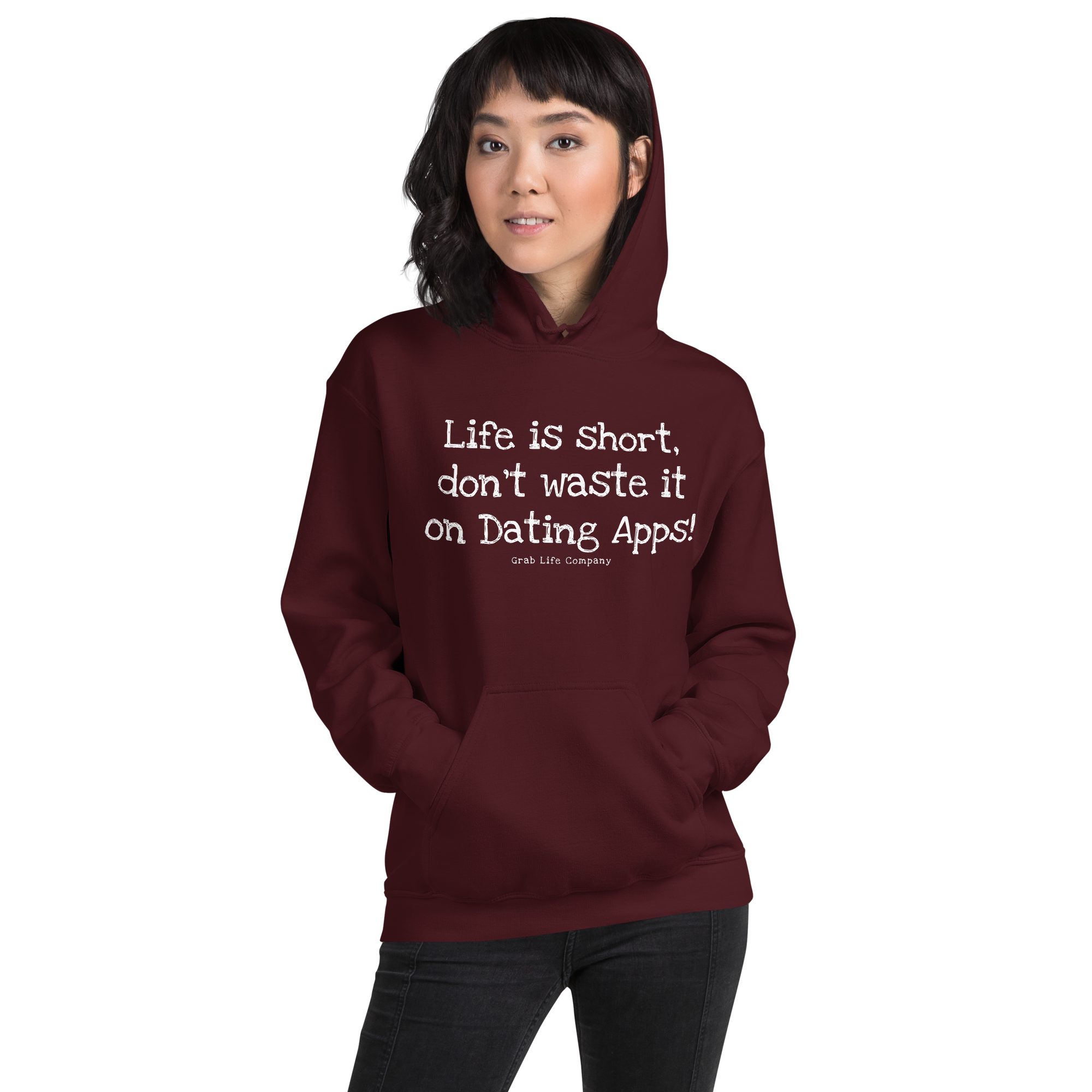 Grab Life Company unisex sweatshirt with Life is Short Don't Waste it on Dating Apps printed in white on maroon hoodie. Image shows woman wearing the sweatshirt.