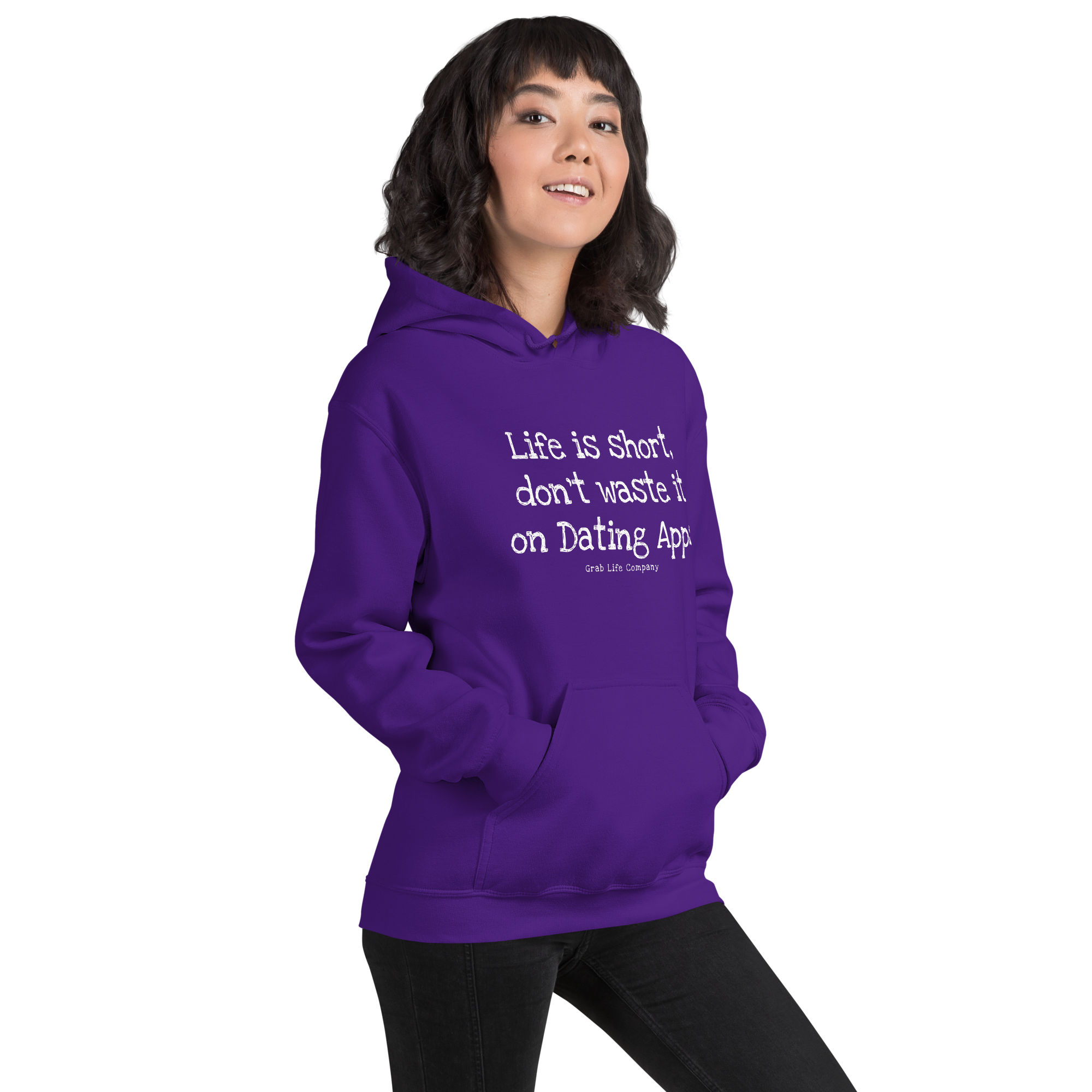 Grab Life Company unisex sweatshirt with Life is Short Don't Waste it on Dating Apps printed in white on purple hoodie. Image shows woman wearing the sweatshirt.