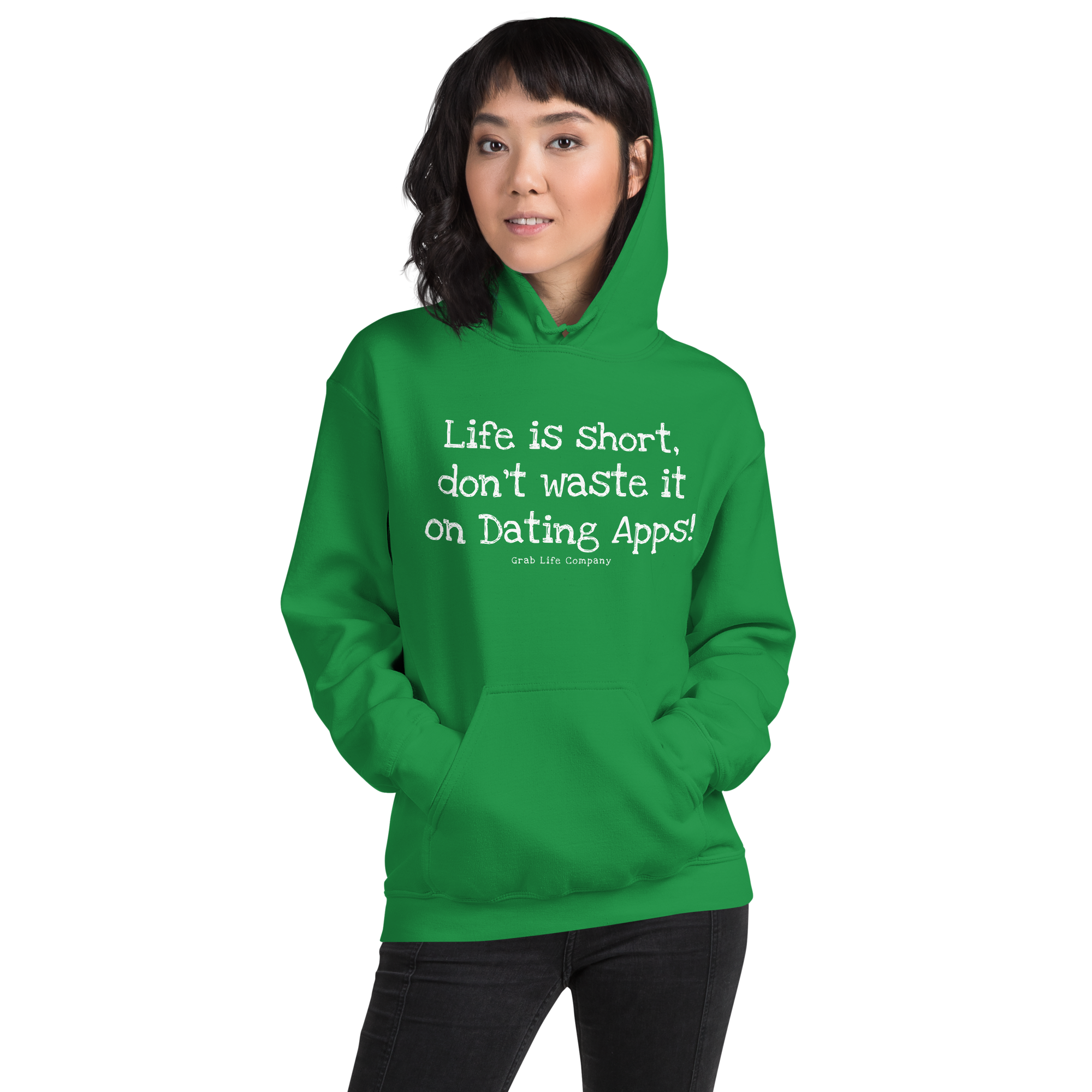Grab Life Company unisex sweatshirt with Life is Short Don't Waste it on Dating Apps printed in white on Irish green hoodie. Image shows woman wearing the sweatshirt.