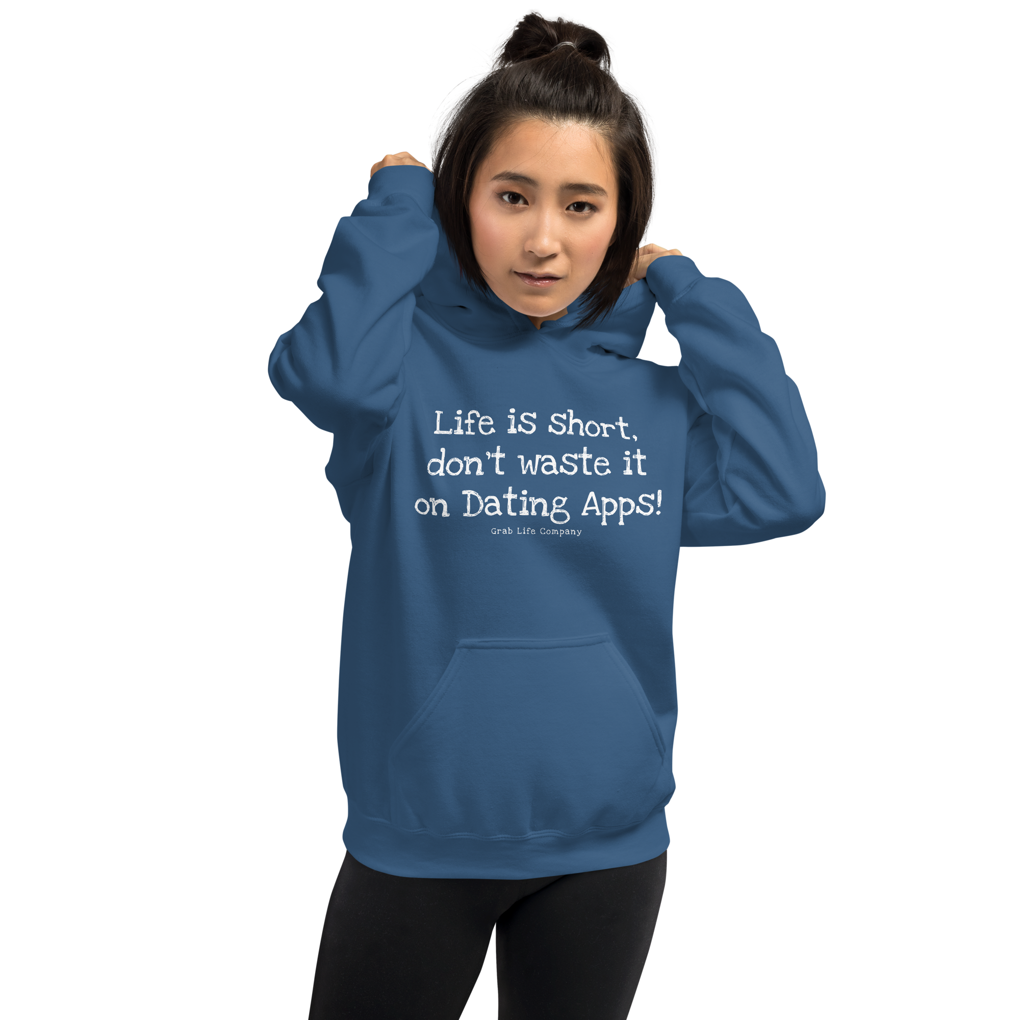 Grab Life Company unisex sweatshirt with Life is Short Don't Waste it on Dating Apps printed in white on indigo blue hoodie. Image shows woman wearing the sweatshirt.