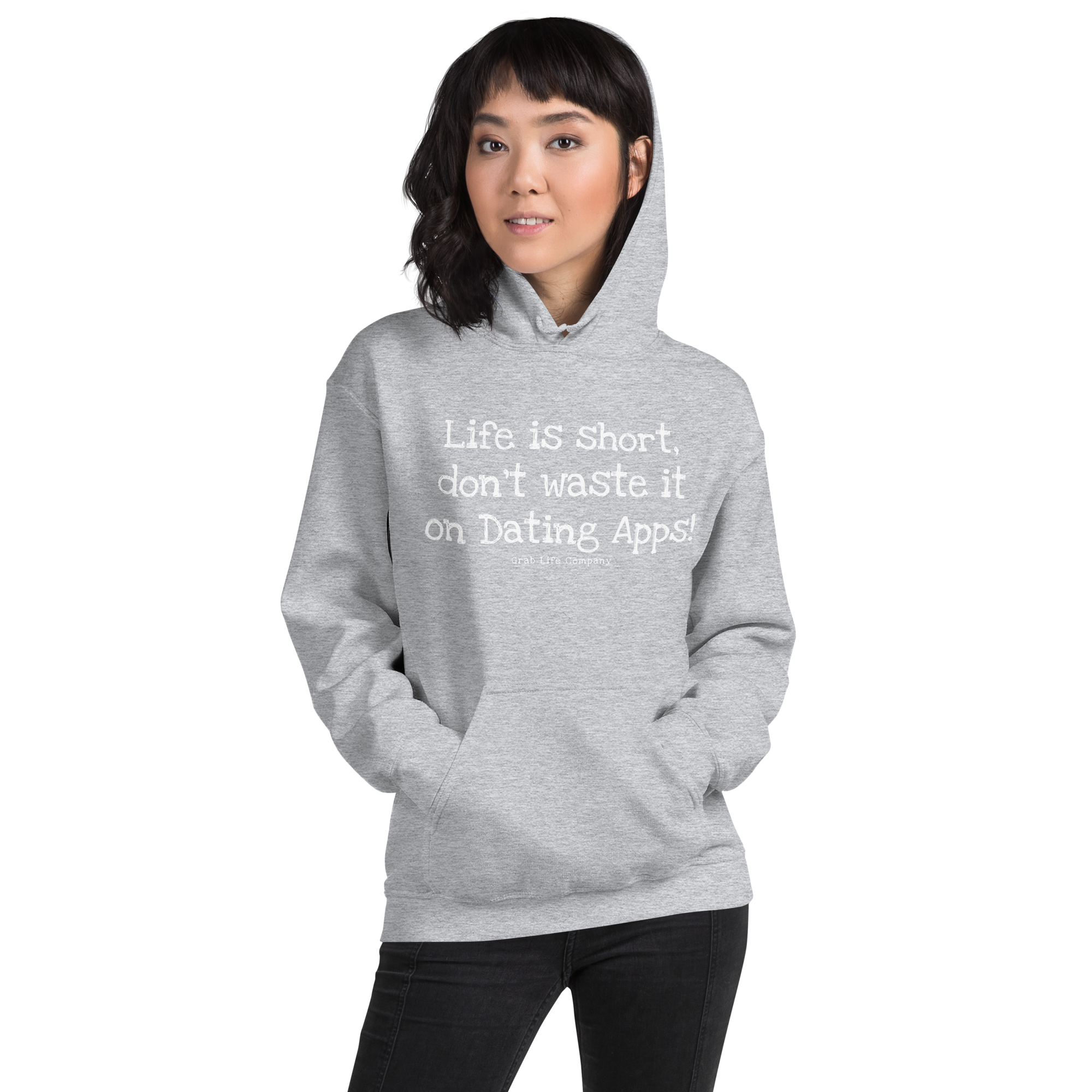 Grab Life Company unisex sweatshirt with Life is Short Don't Waste it on Dating Apps printed in white on sport grey hoodie. Image shows woman wearing the sweatshirt.