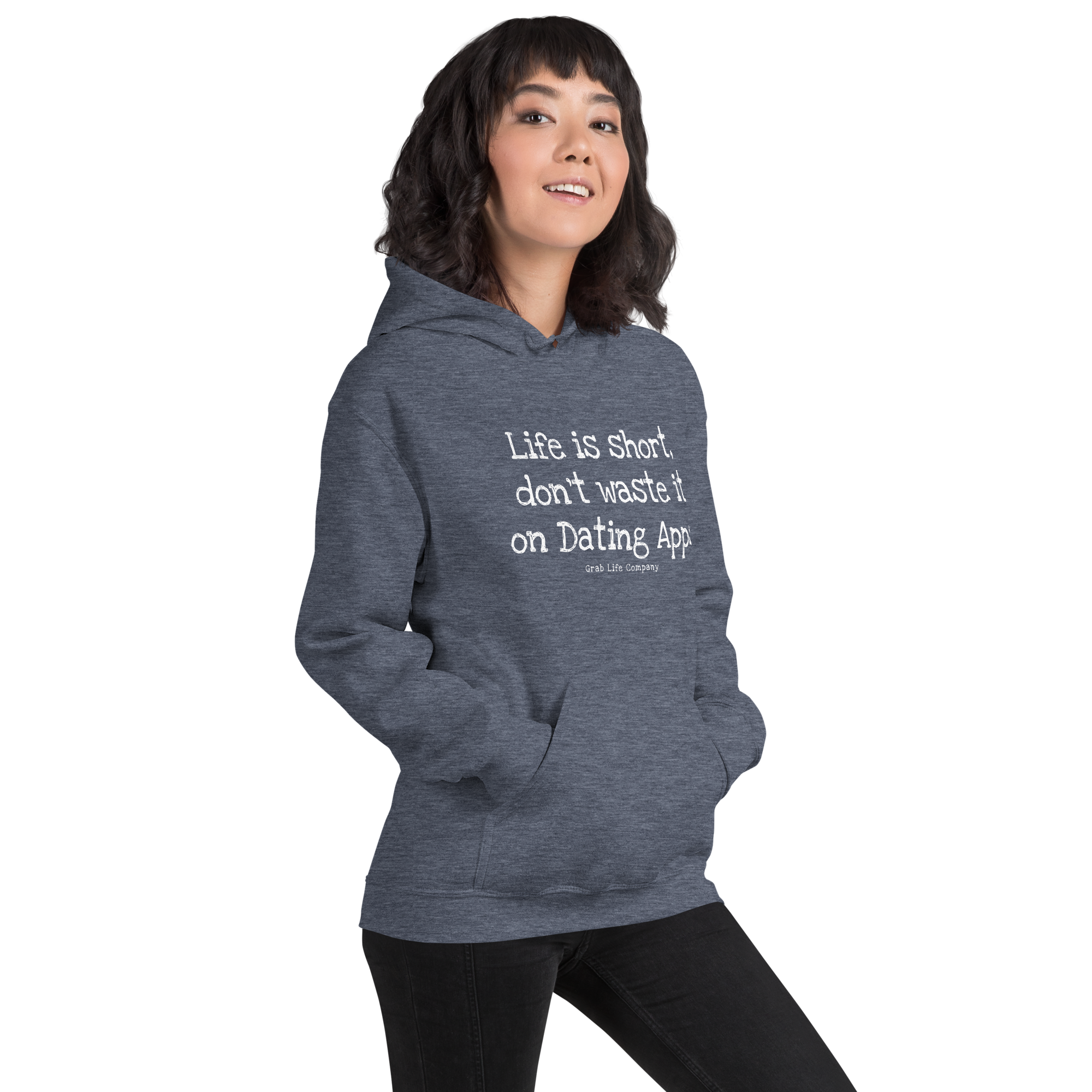 Grab Life Company unisex sweatshirt with Life is Short Don't Waste it on Dating Apps printed in white on heather sport dark navy hoodie. Image shows woman wearing the sweatshirt.