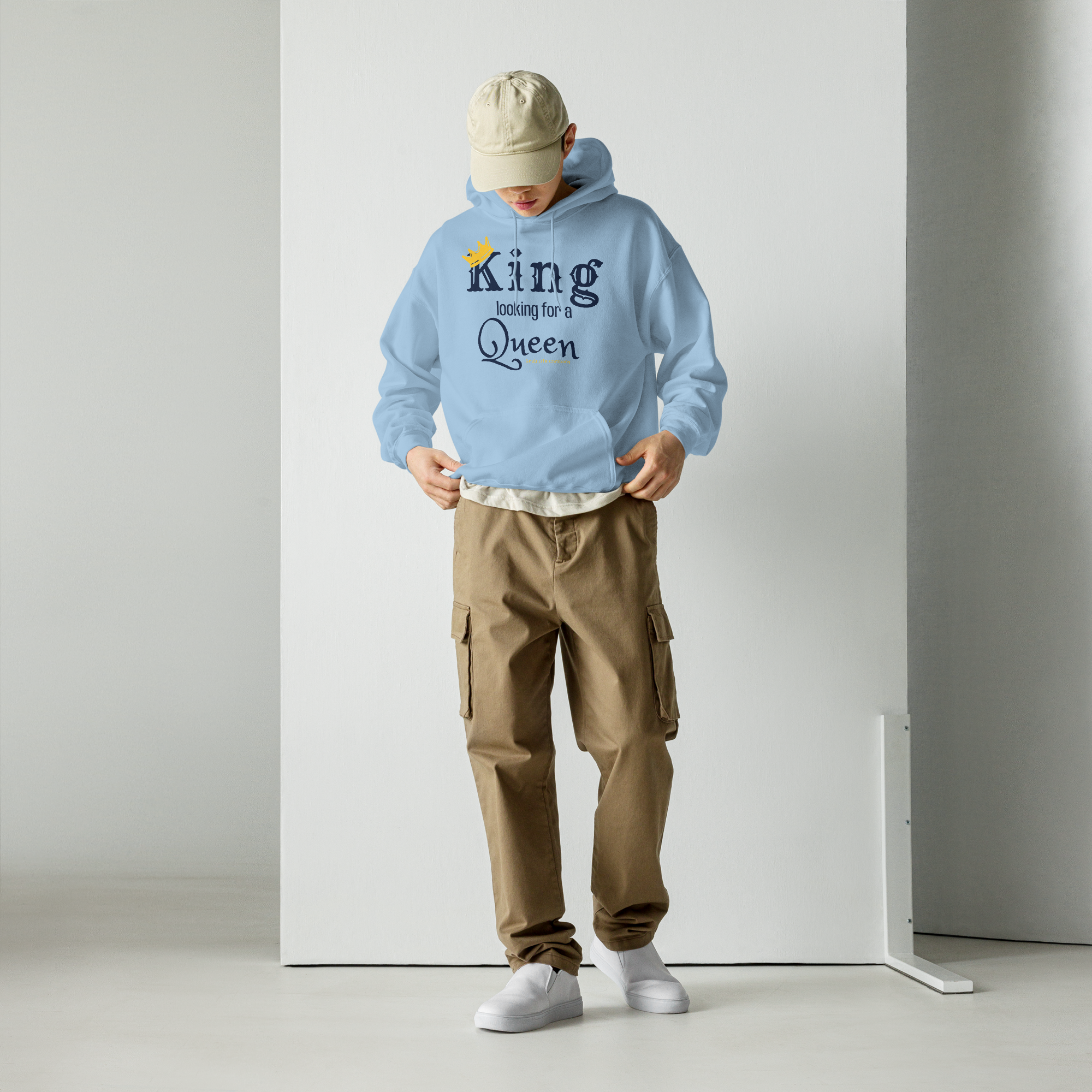 Grab Life Company unisex hoodie with King Looking for a Queen printed in navy blue on the light blue sweatshirt. Image shows a man wearing the shirt.