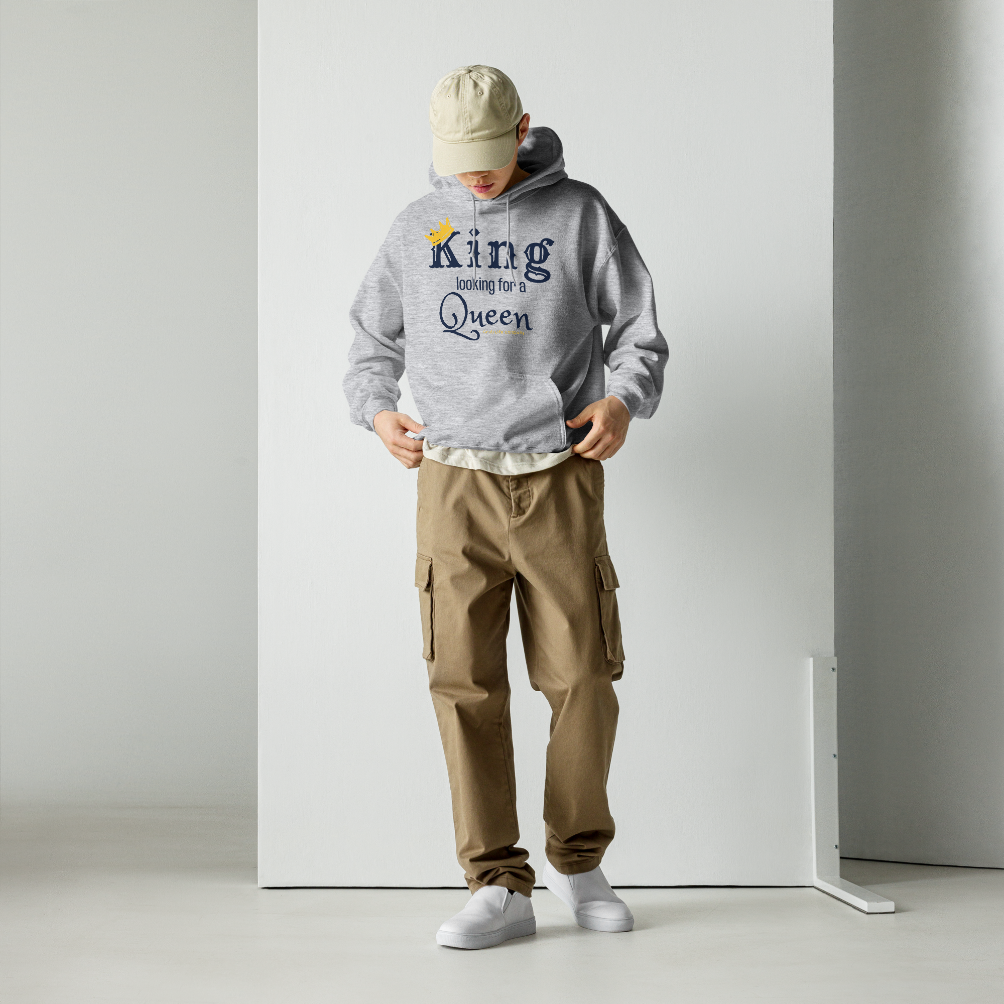 Grab Life Company unisex hoodie with King Looking for a Queen printed in navy blue on a sport grey sweatshirt. Image shows a man wearing the shirt.