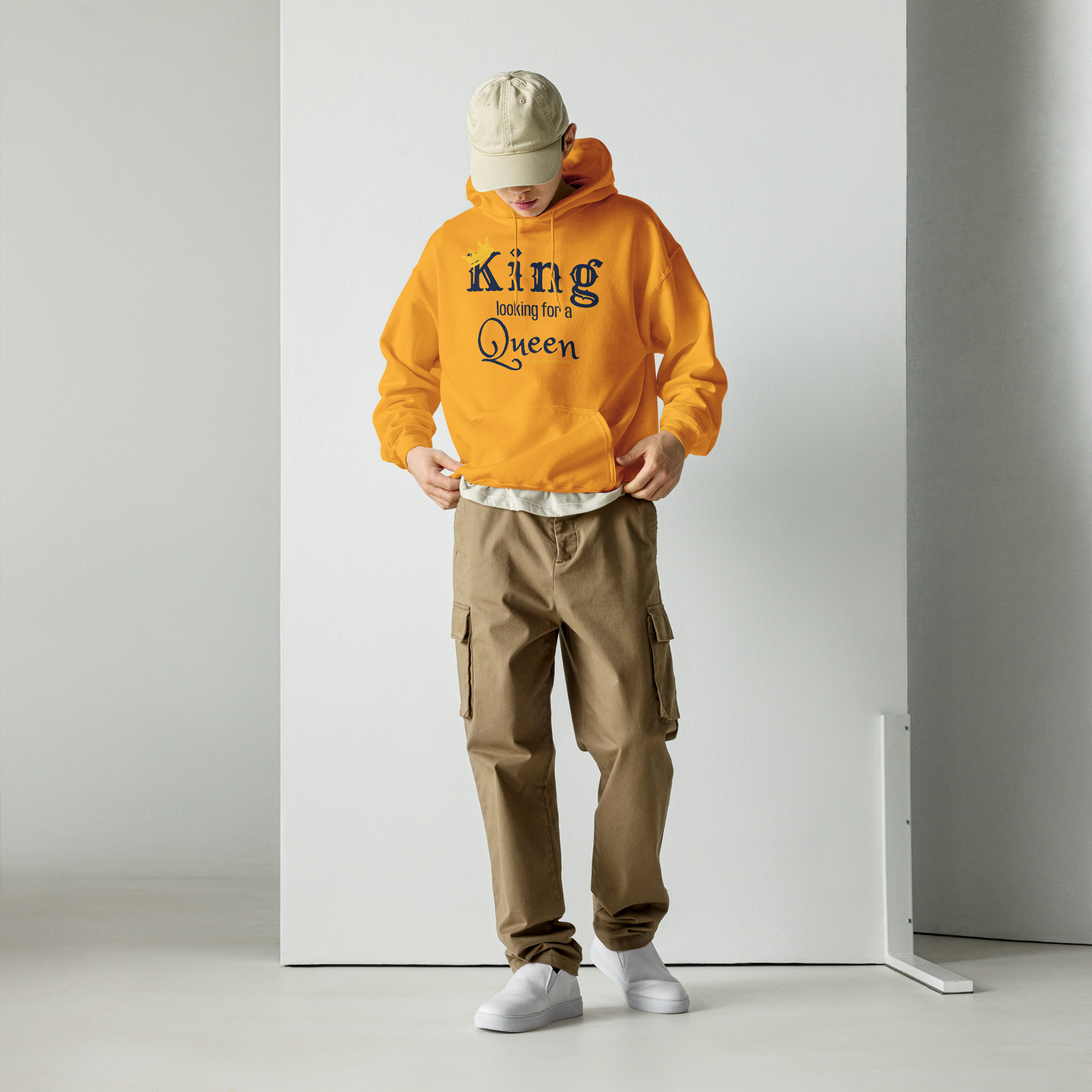 Grab Life Company unisex hoodie with King Looking for a Queen printed in navy blue on a Gold yellow sweatshirt. Image shows a man wearing the shirt.