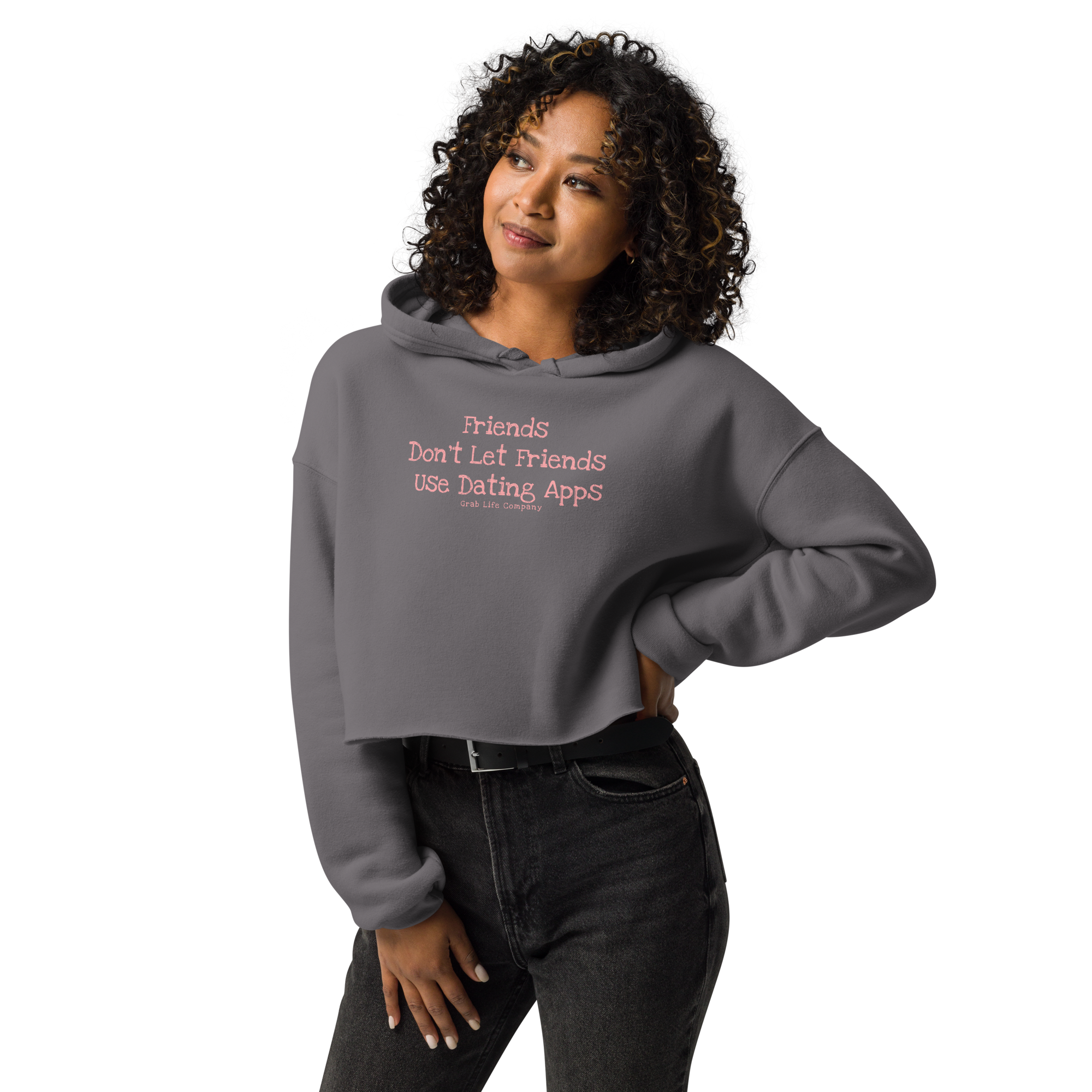 Grab Life Company cropped hoodie with Friends don't let Friends use Dating Apps printed on the front in pink on grey sweatshirt. Image shows a woman wearing the hoodie.
