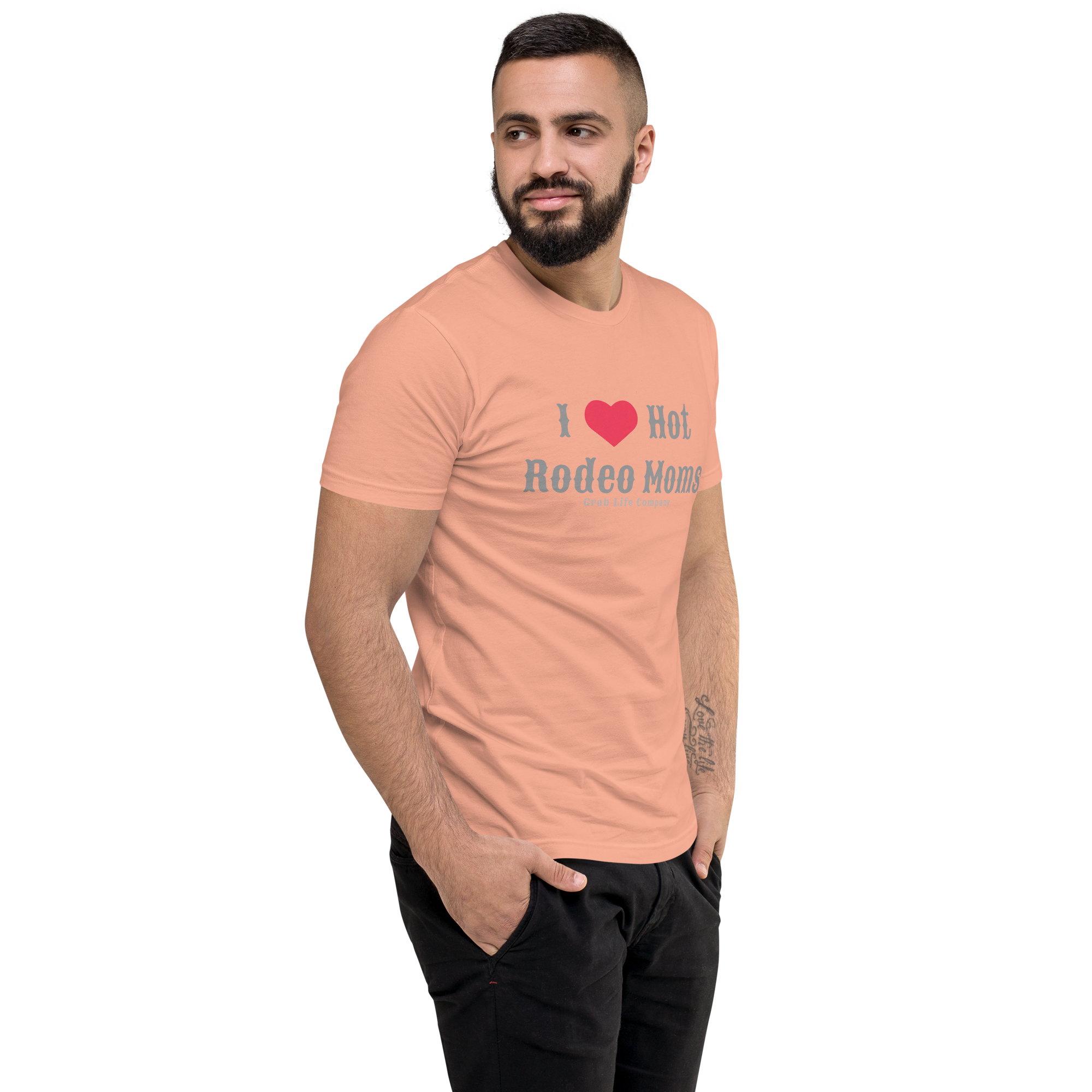 Grab Life Company men's fitted t-shirt printed with I Heart Hot Rodeo Moms in grey on a desert pink tee. Image shows a man wearing the shirt.