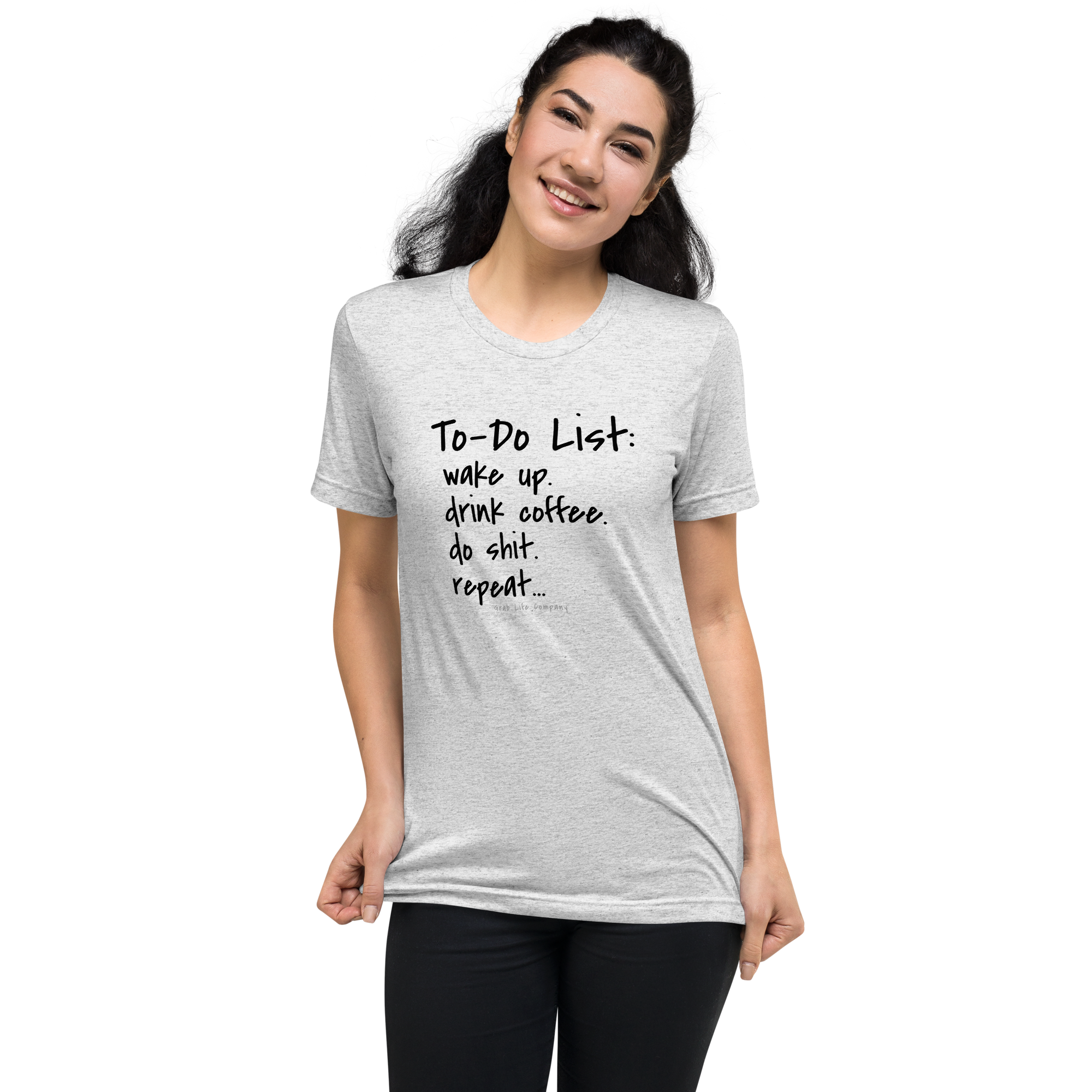 Grab Life Company unisex t-shirt with To-Do List: wake up. drink coffee. do shit. repeat. written on the front in black on a white fleck triblend tee. Image shows a woman wearing the shirt.