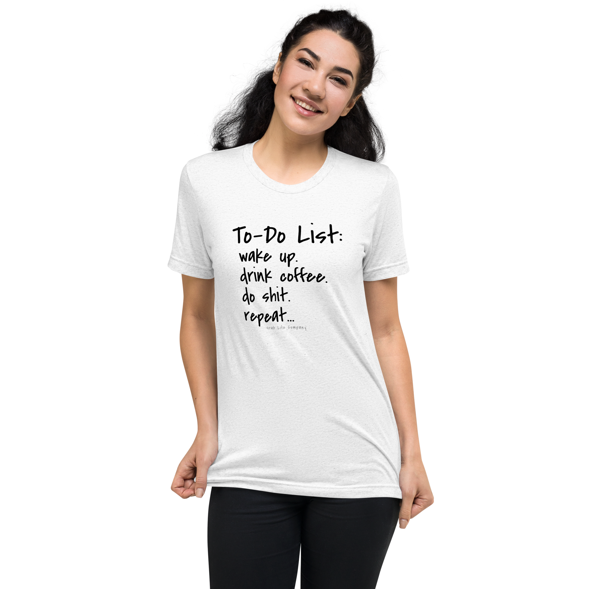 Grab Life Company unisex t-shirt with To-Do List: wake up. drink coffee. do shit. repeat. written on the front in black on a solid white triblend tee. Image shows a woman wearing the shirt.