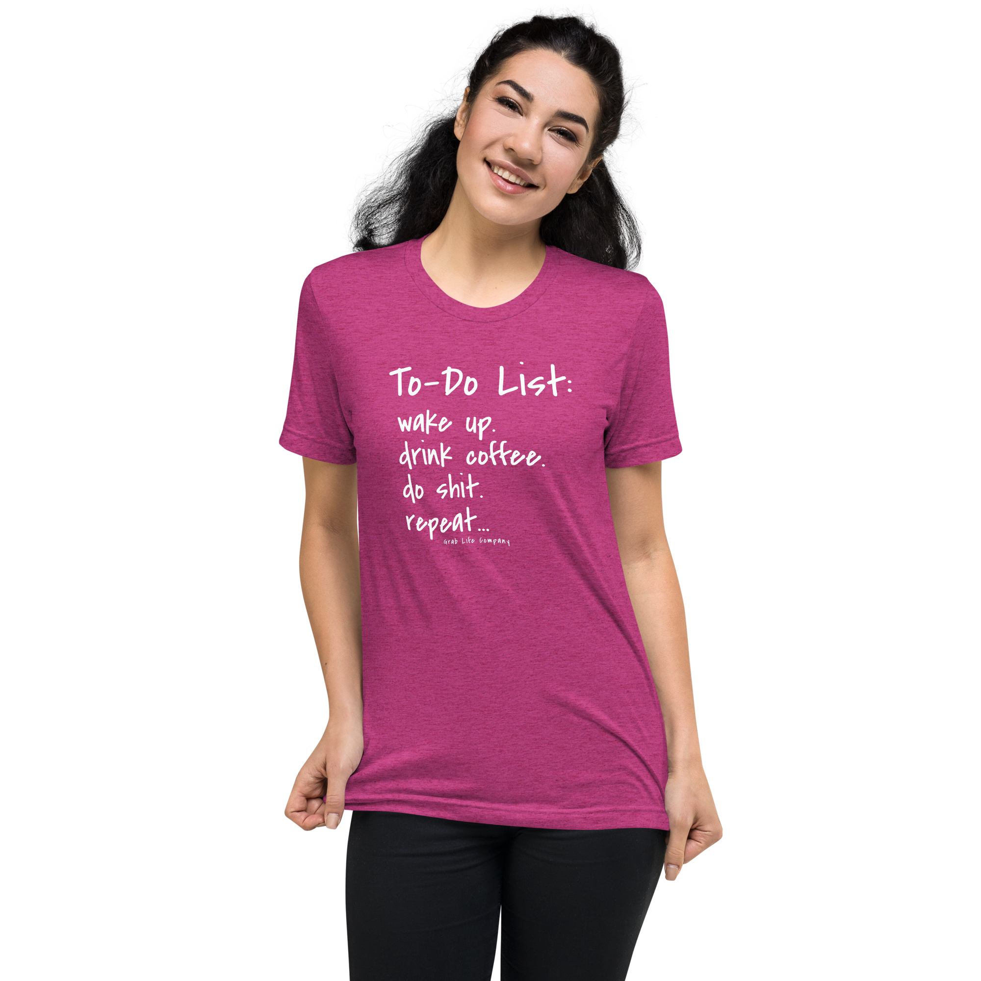Grab Life Company unisex t-shirt with To-Do List: wake up. drink coffee. do shit. repeat. written on the front in white on a berry triblend tee. Image shows a woman wearing the shirt.