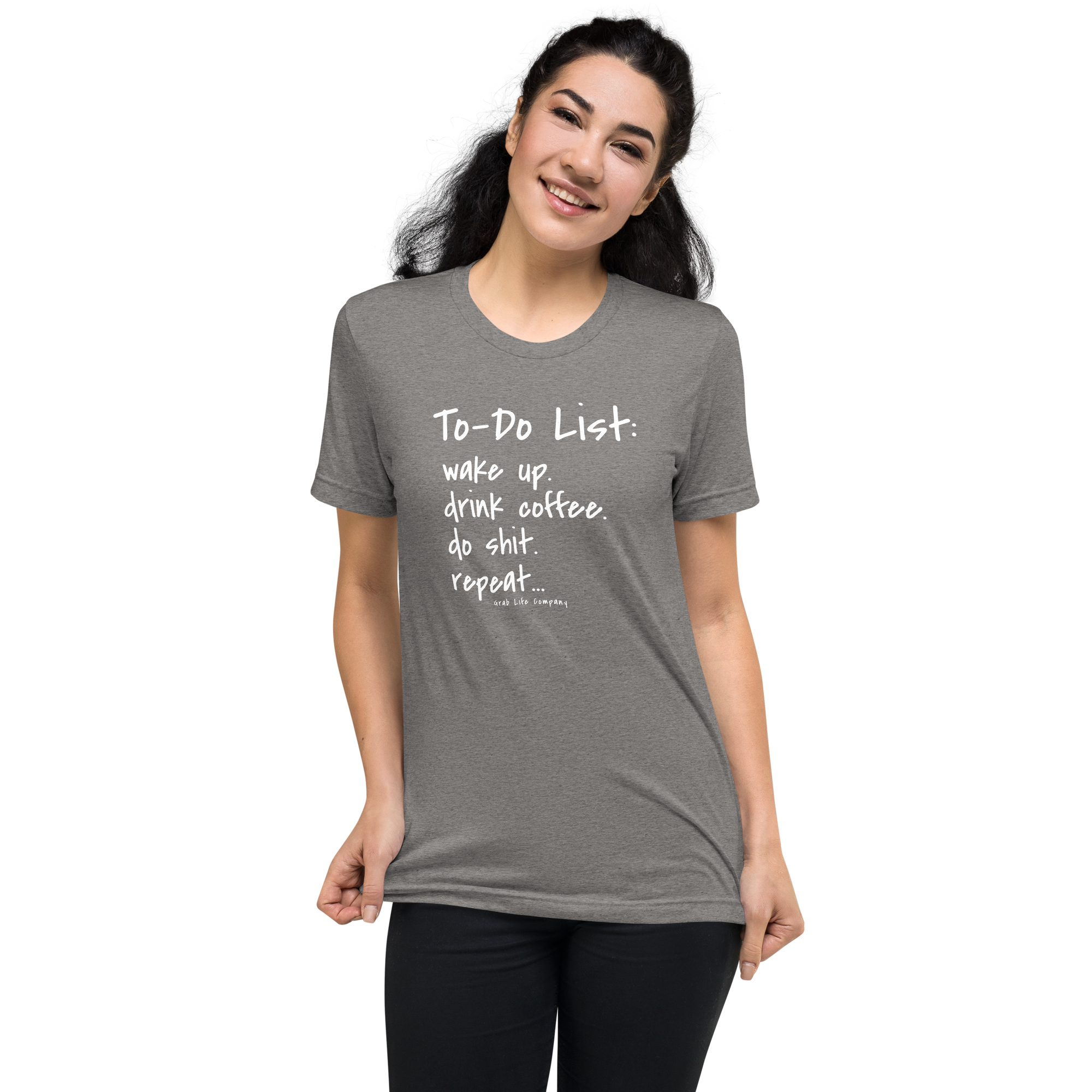 Grab Life Company unisex t-shirt with To-Do List: wake up. drink coffee. do shit. repeat. written on the front in white on a grey triblend tee. Image shows a woman wearing the shirt.
