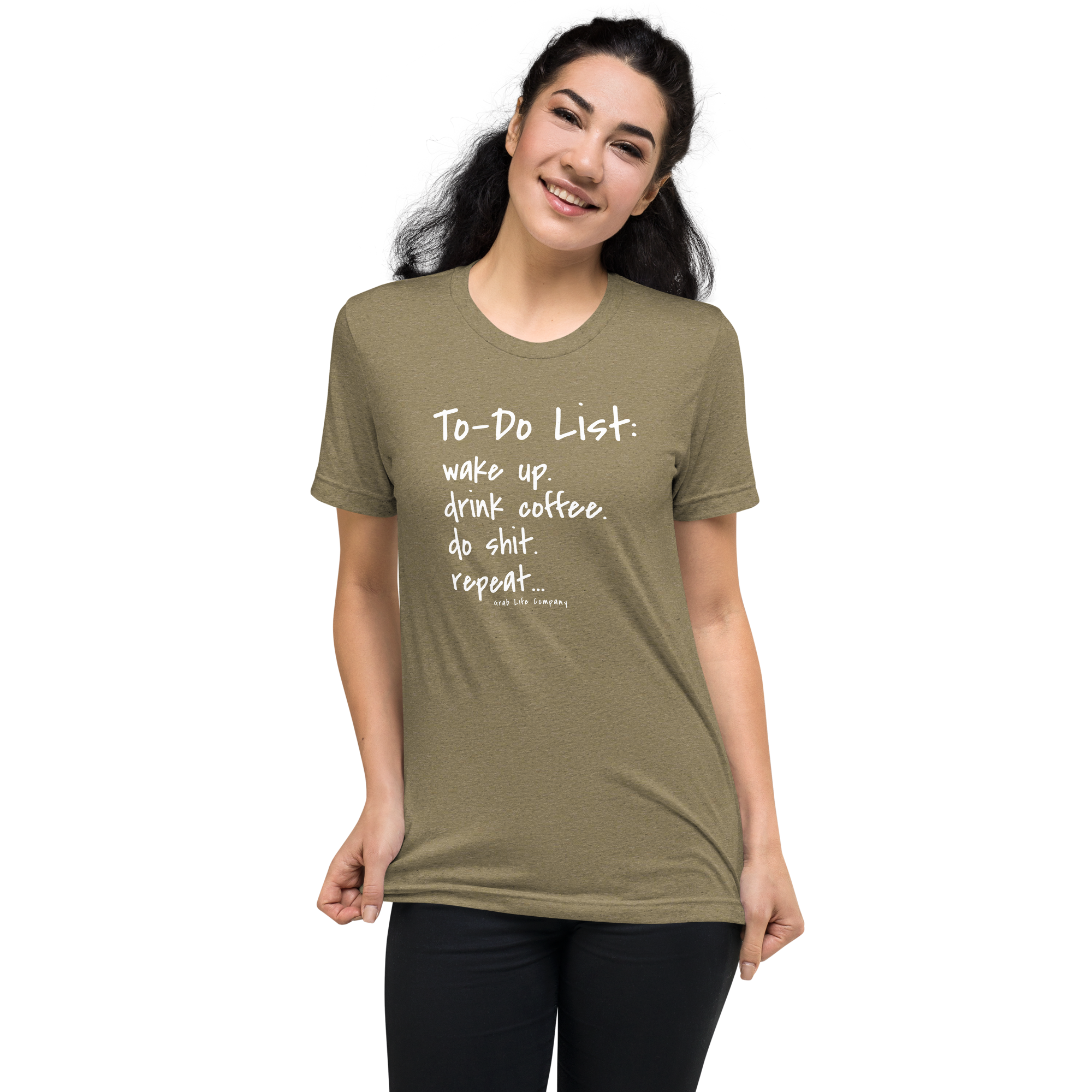 Grab Life Company unisex t-shirt with To-Do List: wake up. drink coffee. do shit. repeat. written on the front in white on an olive triblend tee. Image shows a woman wearing the shirt.
