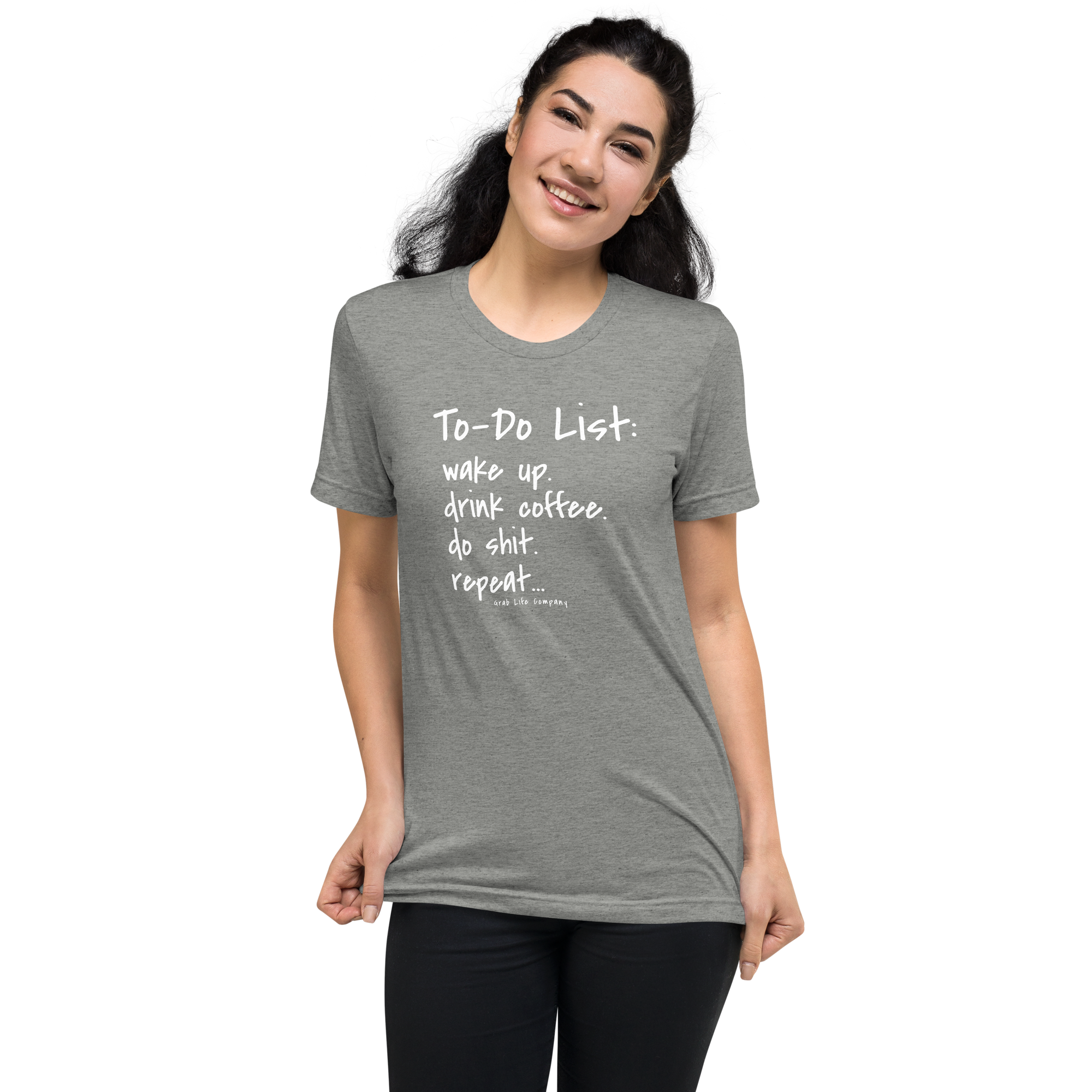 Grab Life Company unisex t-shirt with To-Do List: wake up. drink coffee. do shit. repeat. written on the front in white on an athletic grey triblend tee. Image shows a woman wearing the shirt.