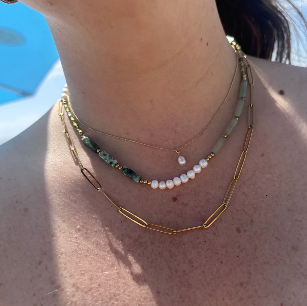 Multi-colored gemstone necklace with freshwater pearl detail.