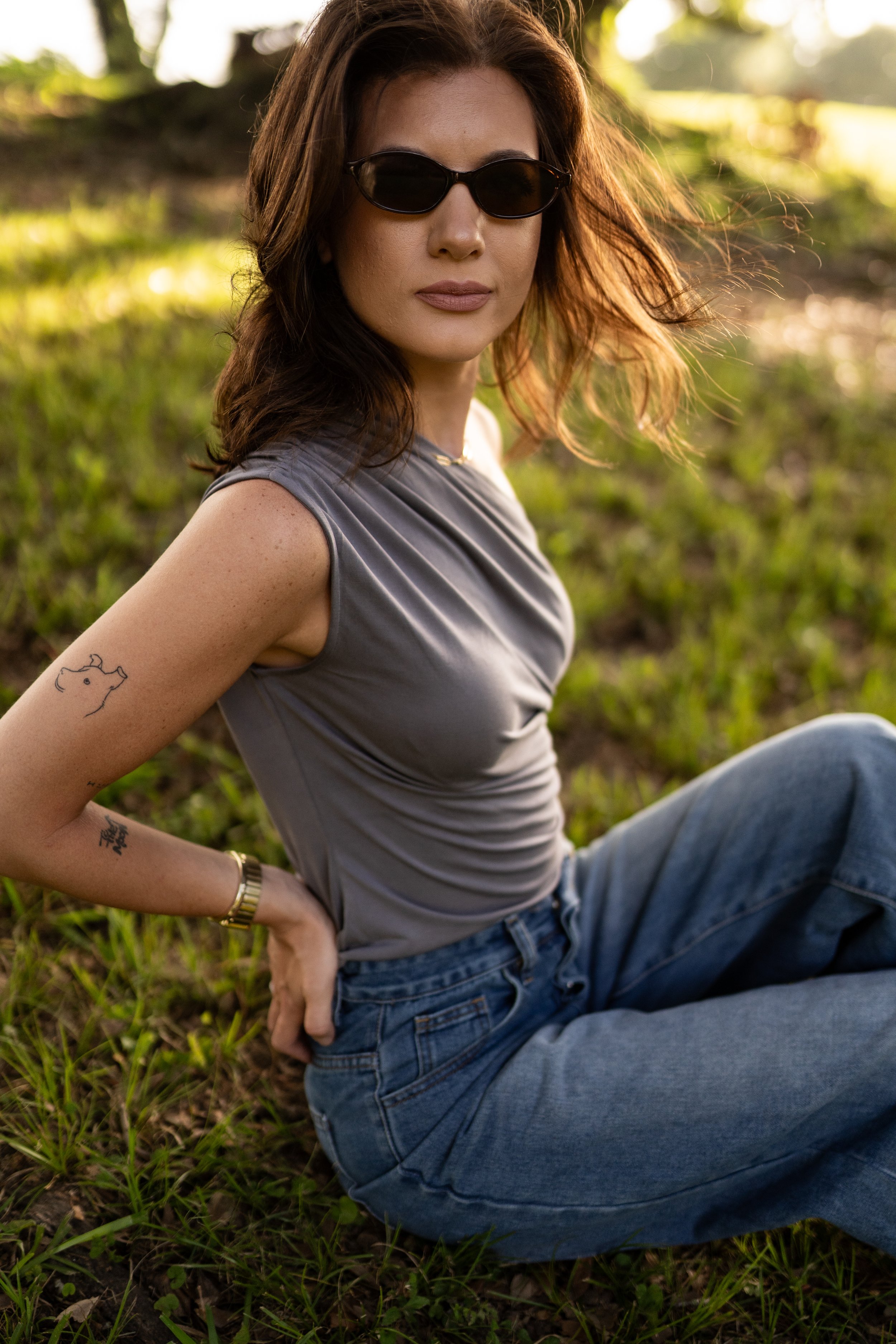 Sleeveless gray fitted top.