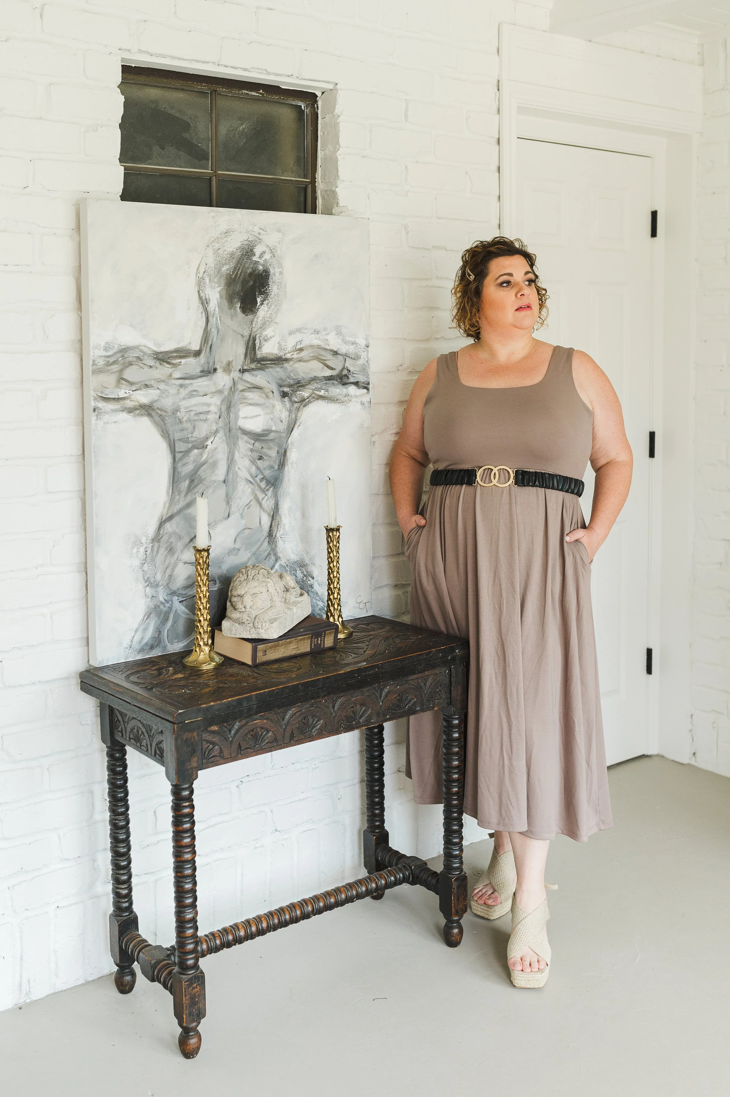 Sleeveless A-line midi dress with a belted waist.