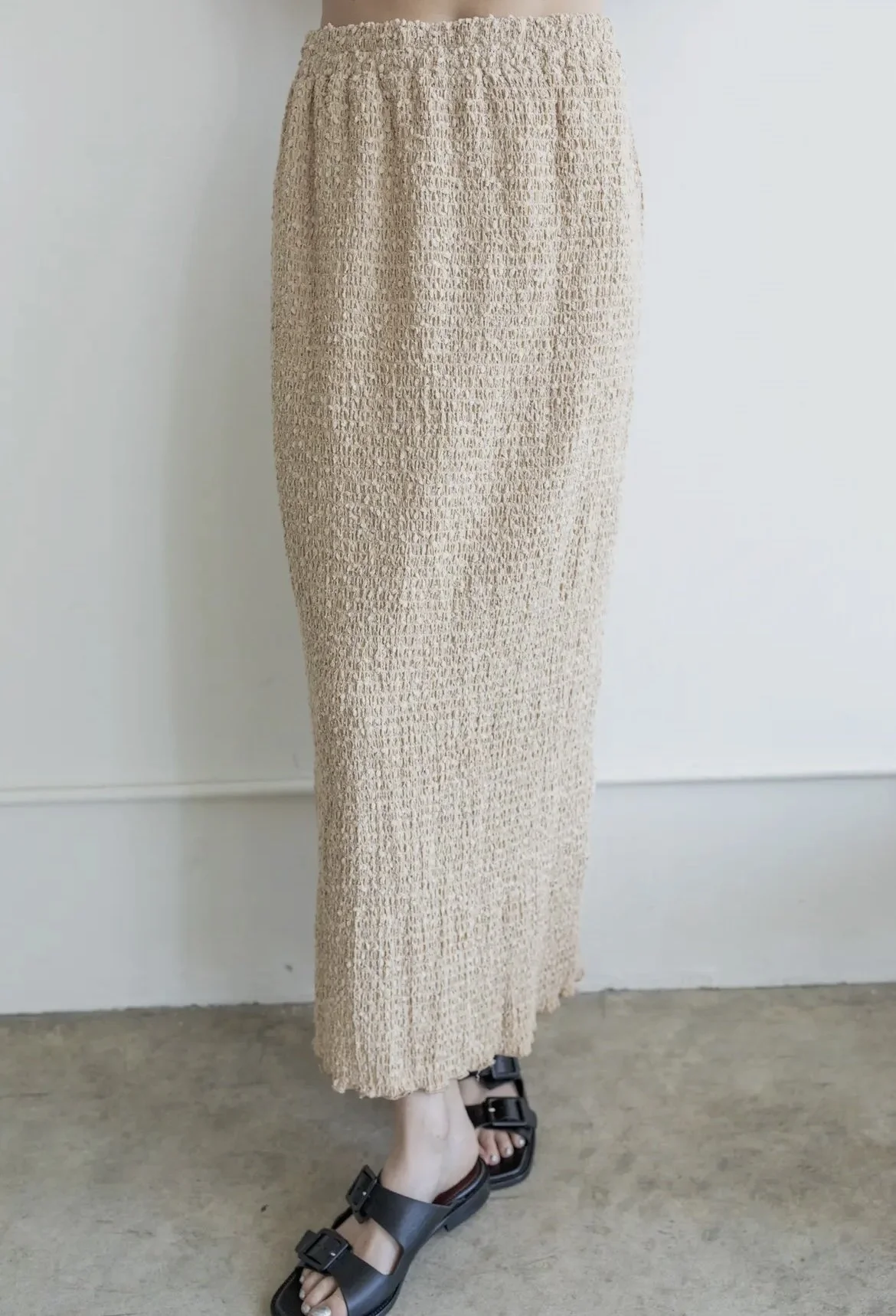 Textured neutral-toned midi skirt with a straight silhouette.