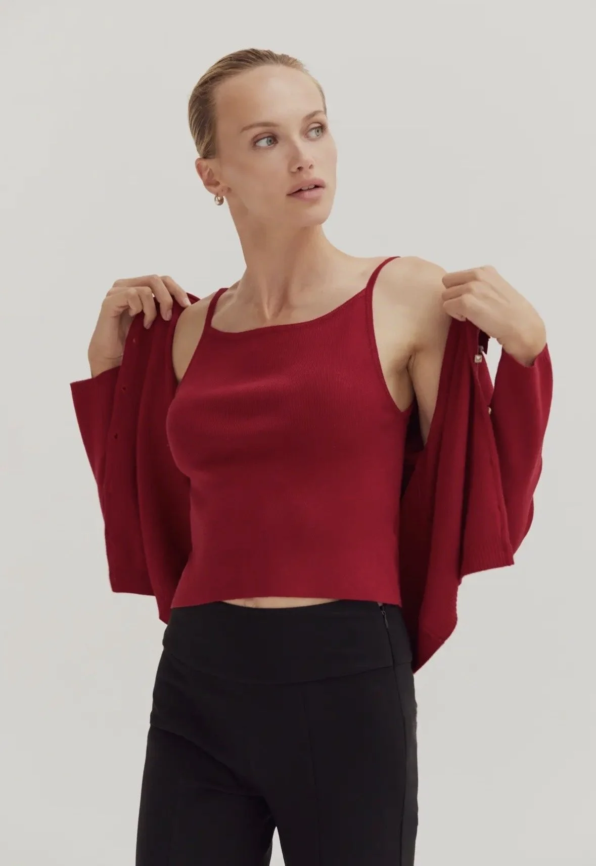 Red sleeveless top with button detail.