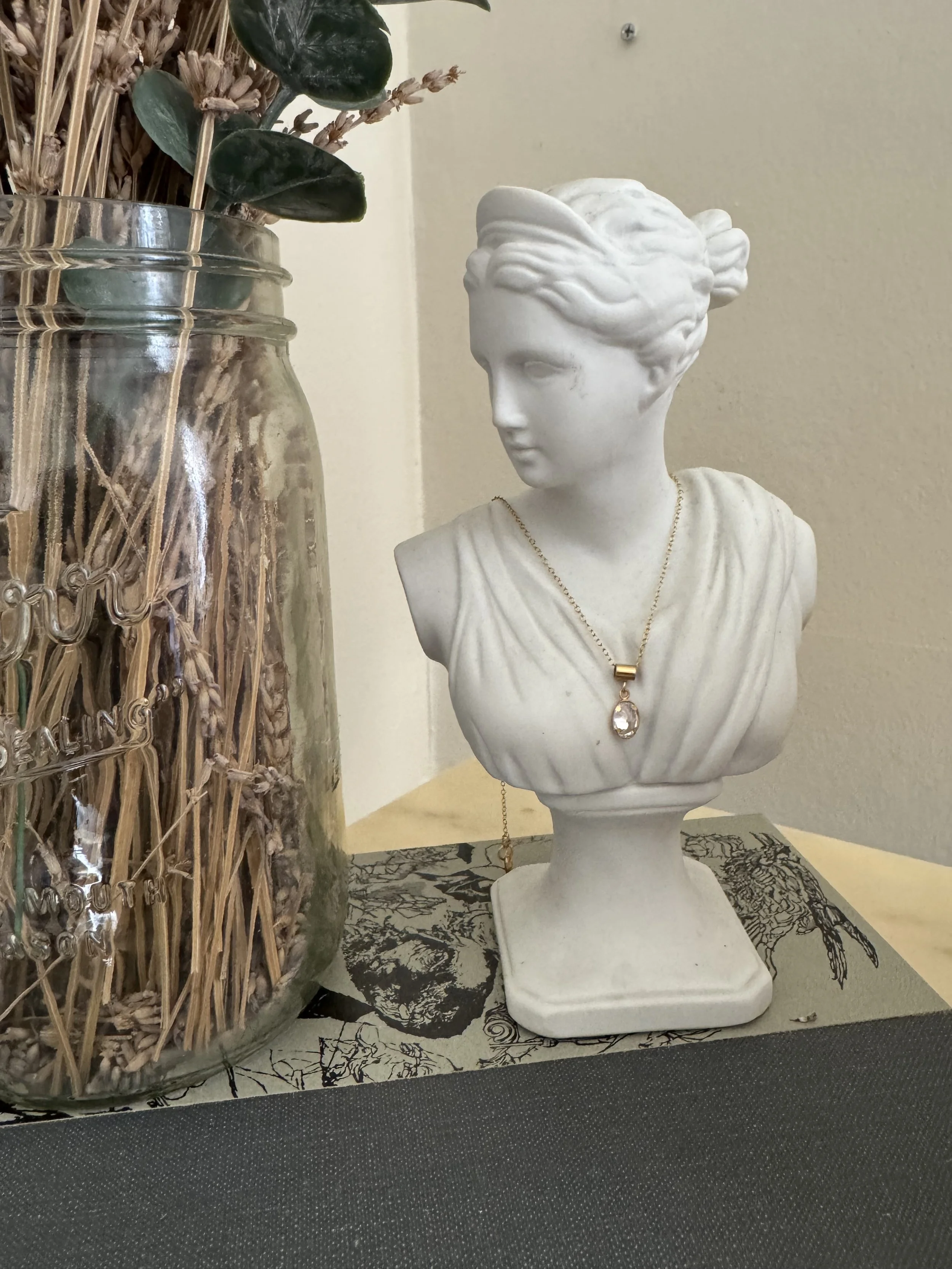 Gold pendant necklace with a minimal design.