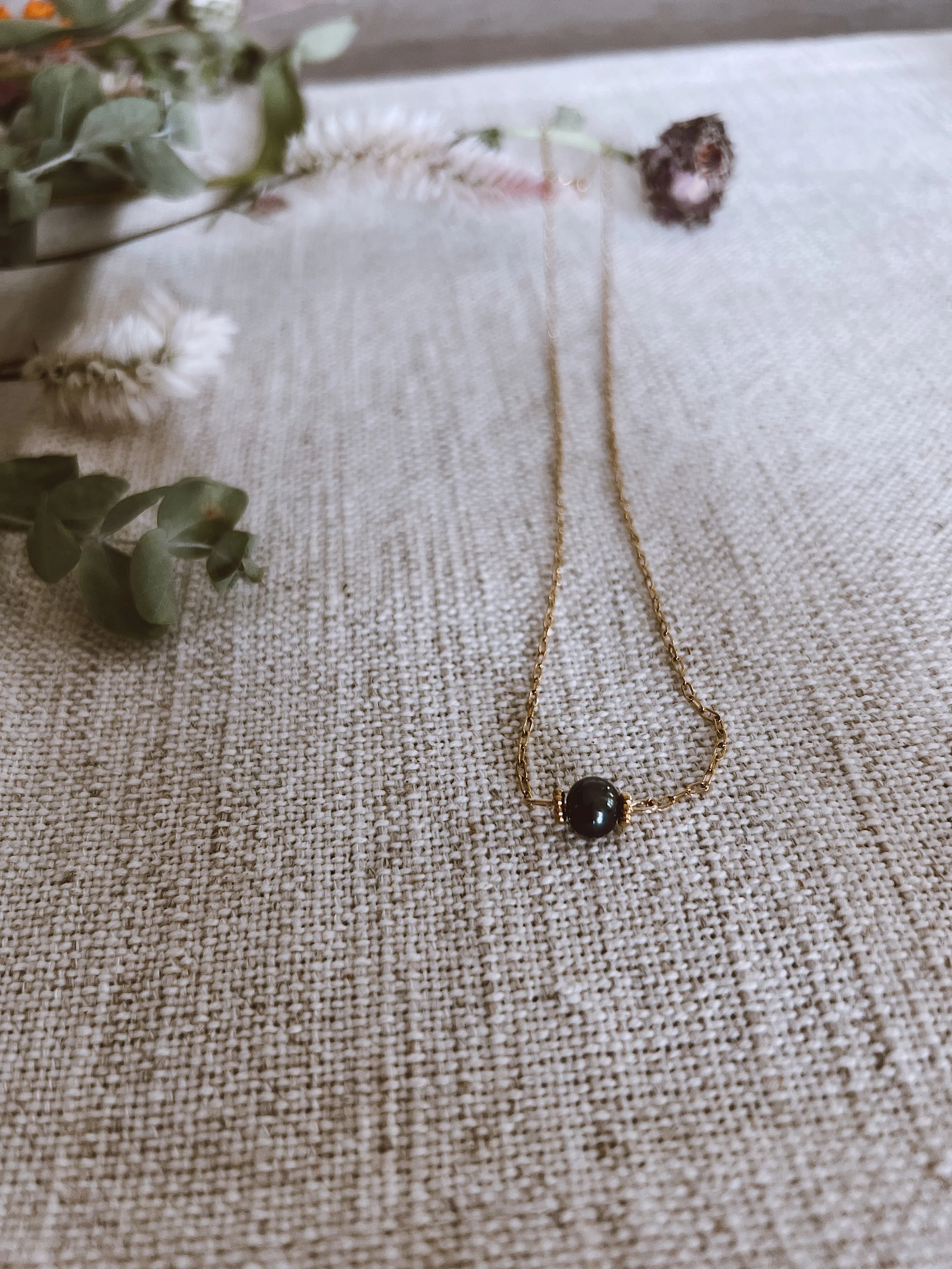 Gold necklace with authentic black pearl pendant.