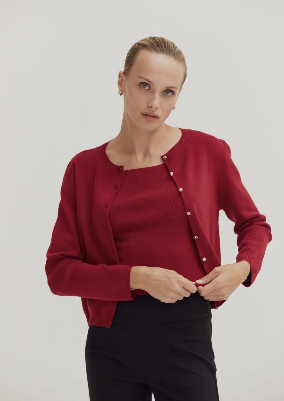 Red sleeveless top with button detail.