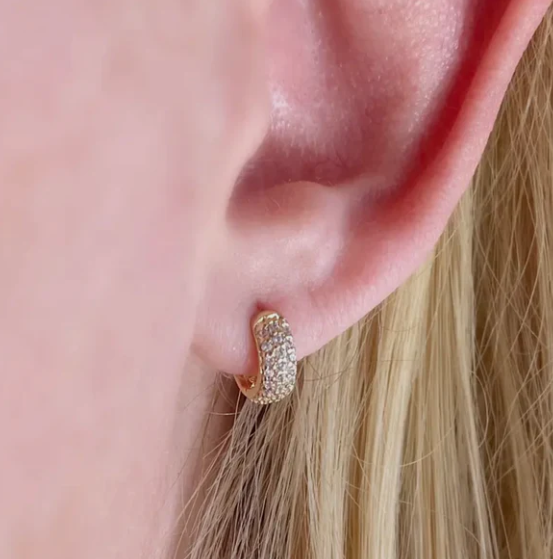 Small gold hoop earrings with textured detail.