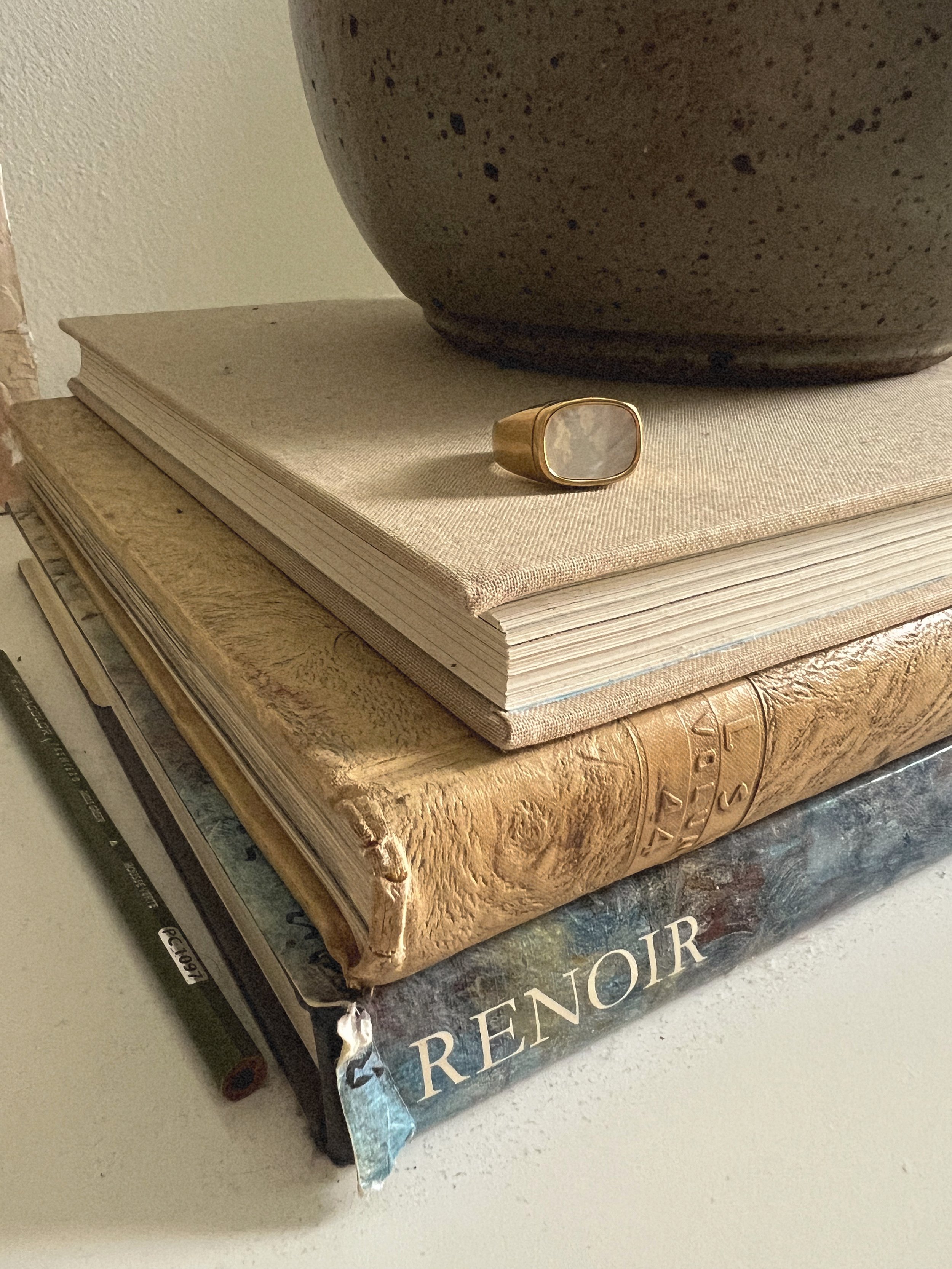 Gold statement ring with an oval stone detail.