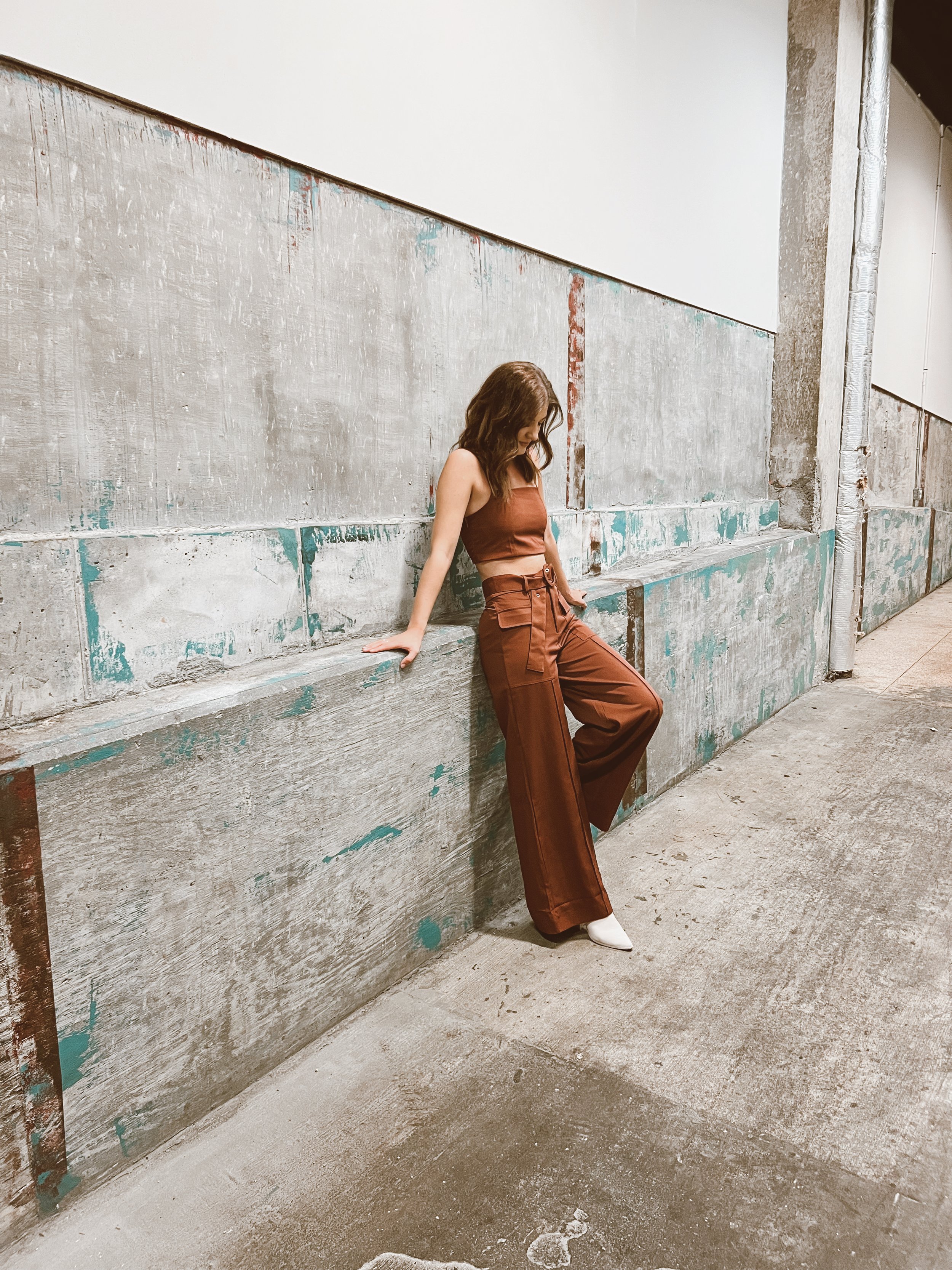 Rust-colored sleeveless top with a fitted silhouette.