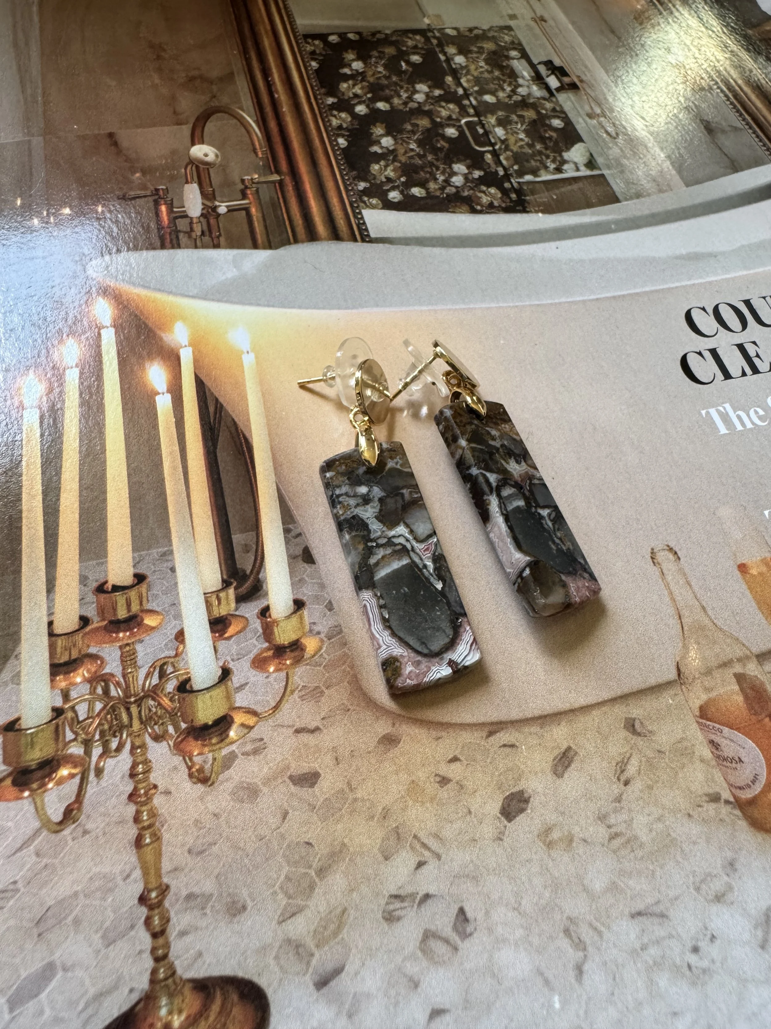 Statement earrings with elongated patterned drop design.