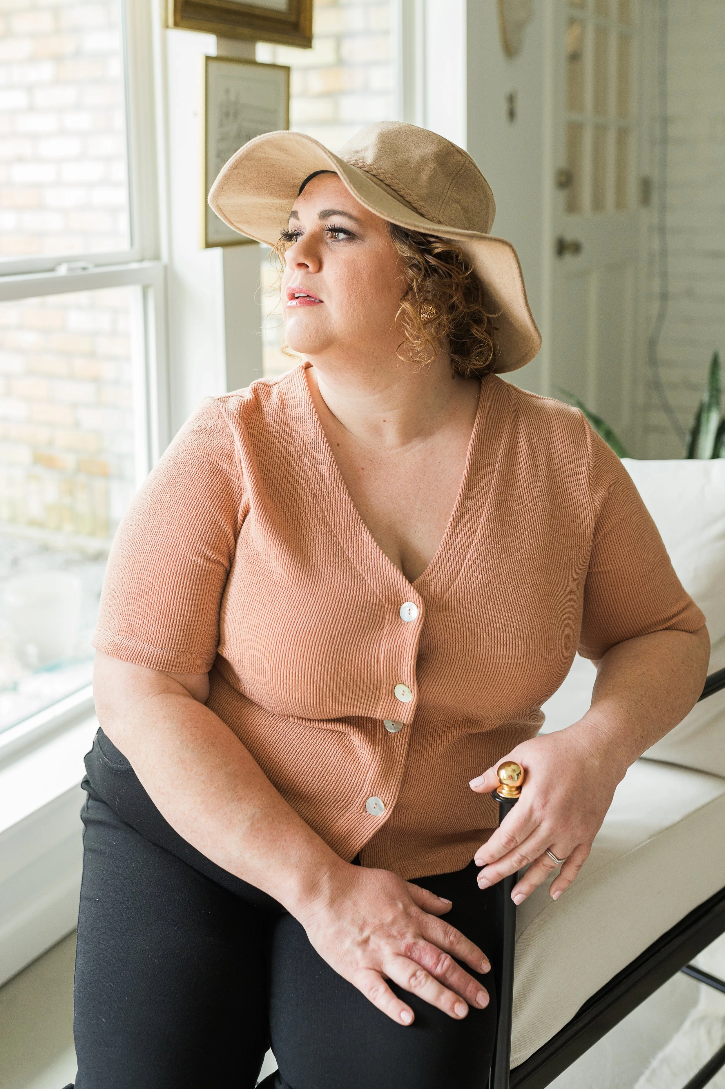 Peach ribbed button-front top with a V-neckline.
