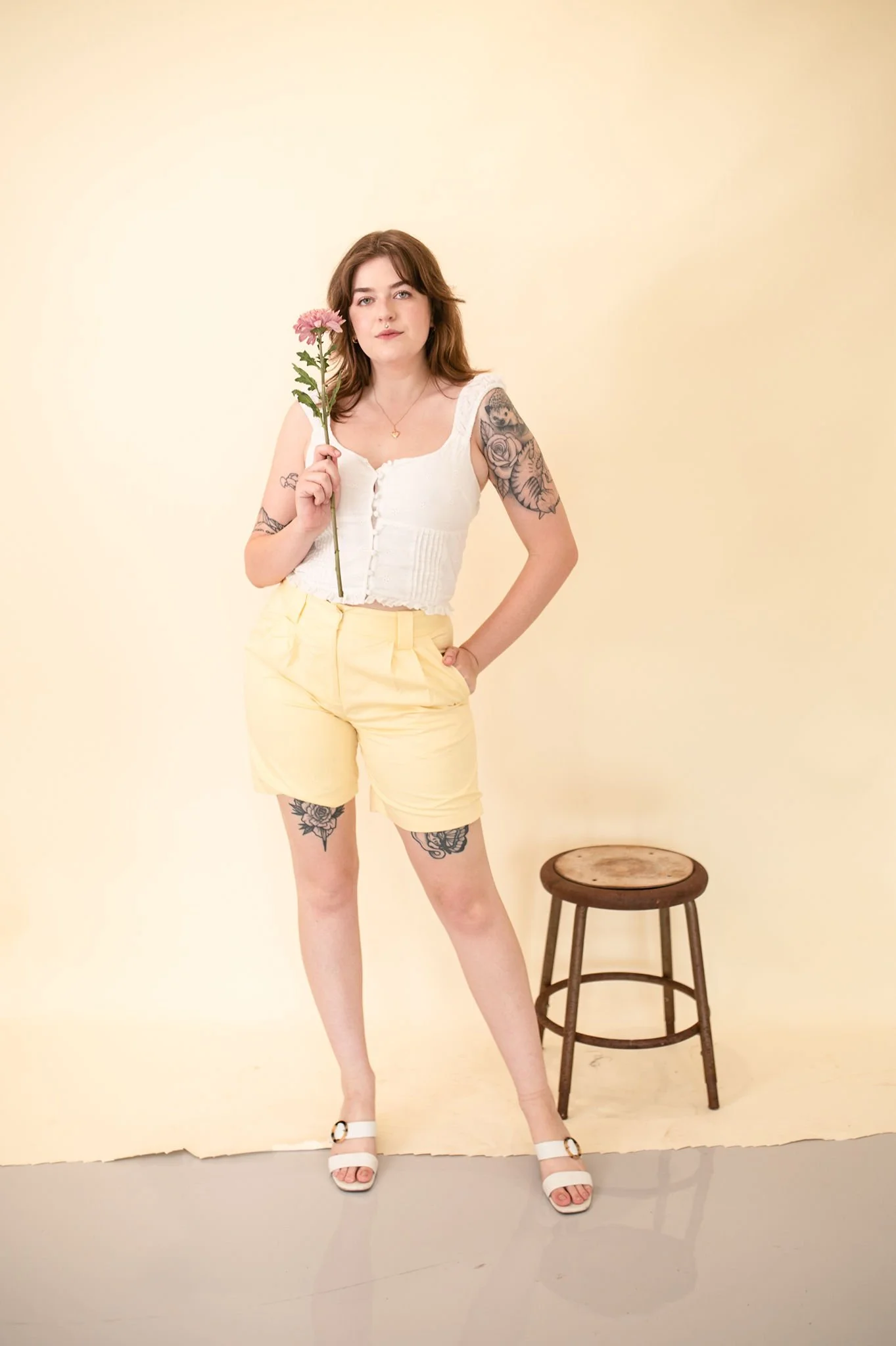 Yellow high-waisted pleated shorts.