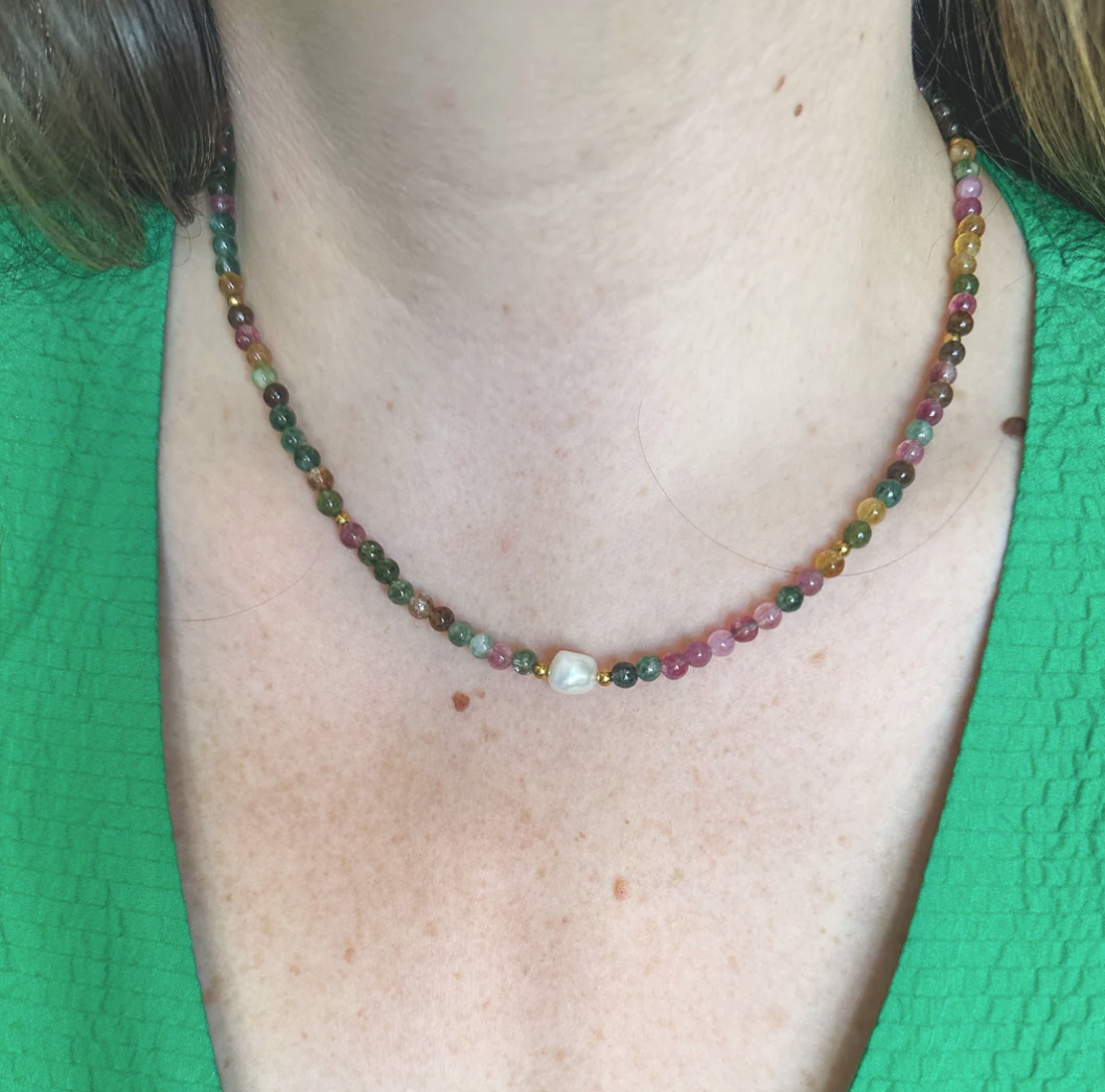 Multi-colored gemstone necklace with freshwater pearl detail.