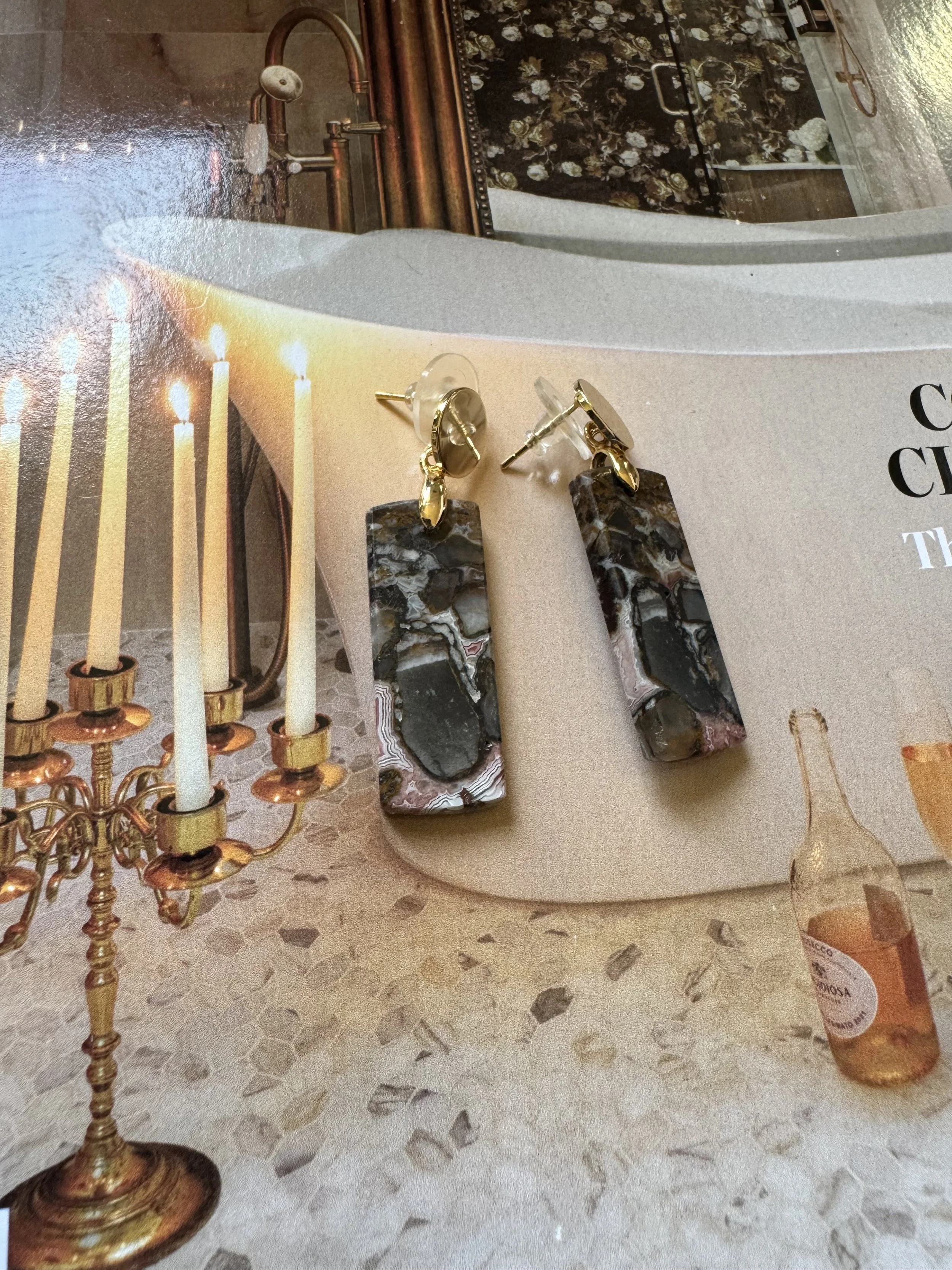 Statement earrings with elongated patterned drop design.