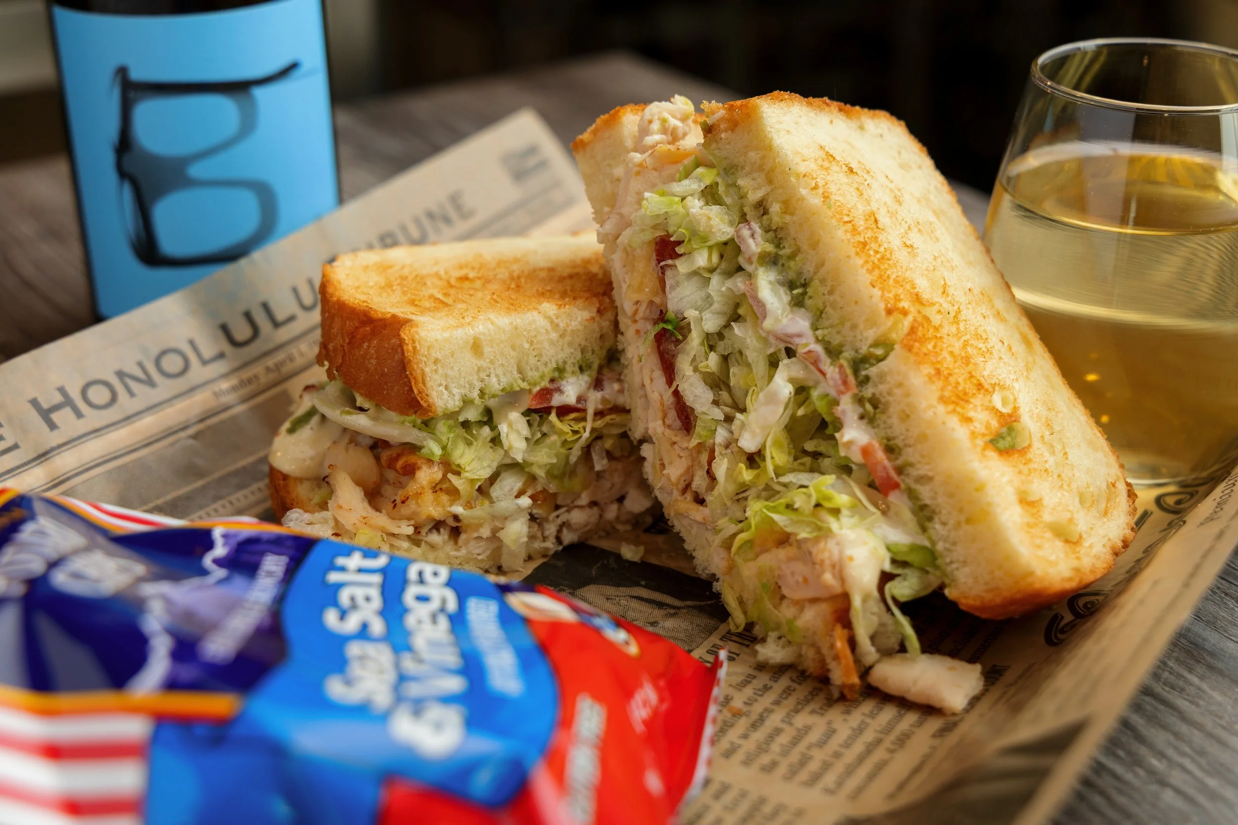 Sandwich, chips, and a glass of wine