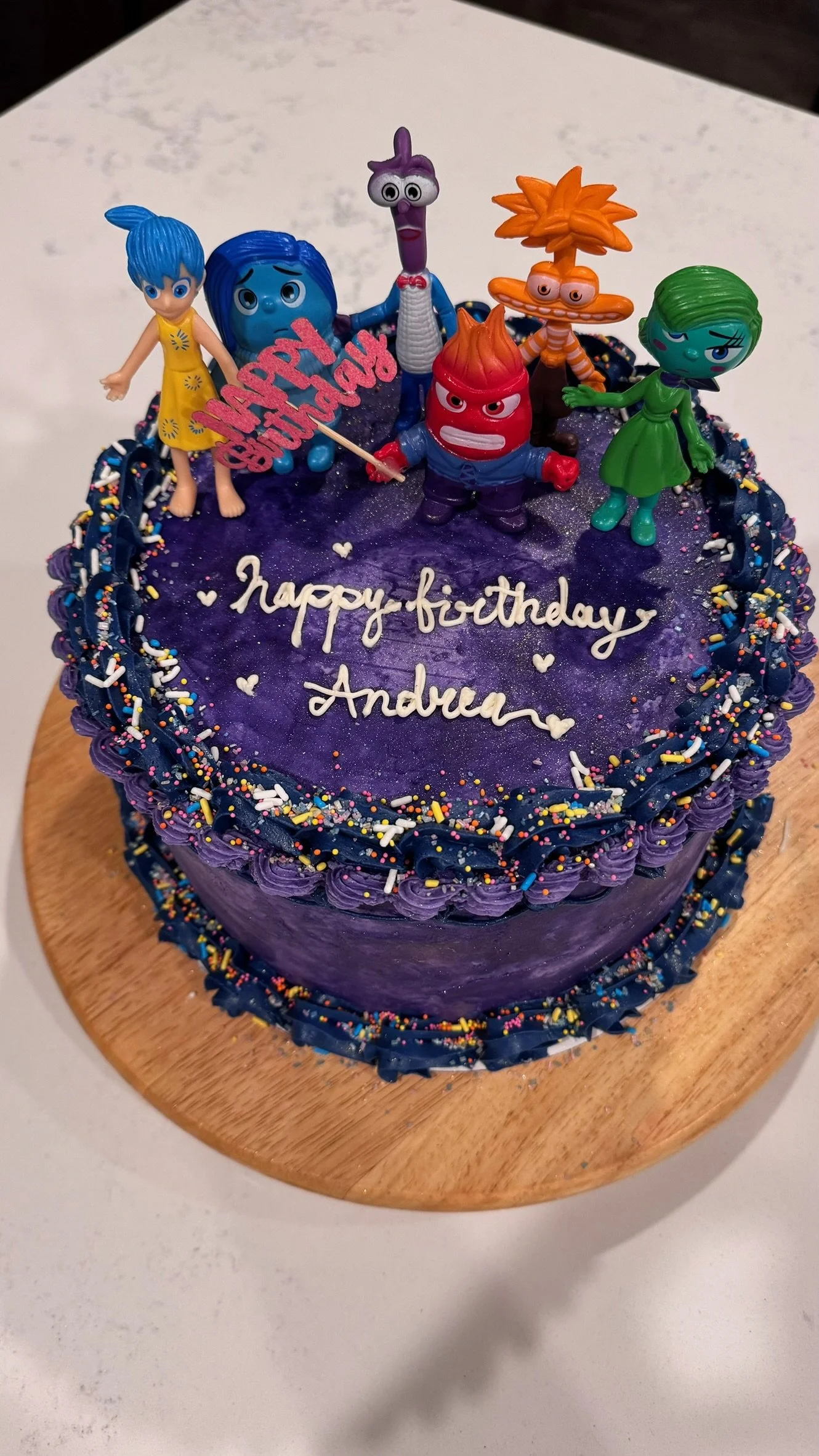 Custom Birthday cake, 8 inch round
Cookies and cream cake with oreo pieces, oreo crumb cream cheese filling, with dark purple and dark blue SMBC icing! Decorated with 'Inside Out' characters, sprinkles and gold dust. Vintage piping style
Serves 15-25